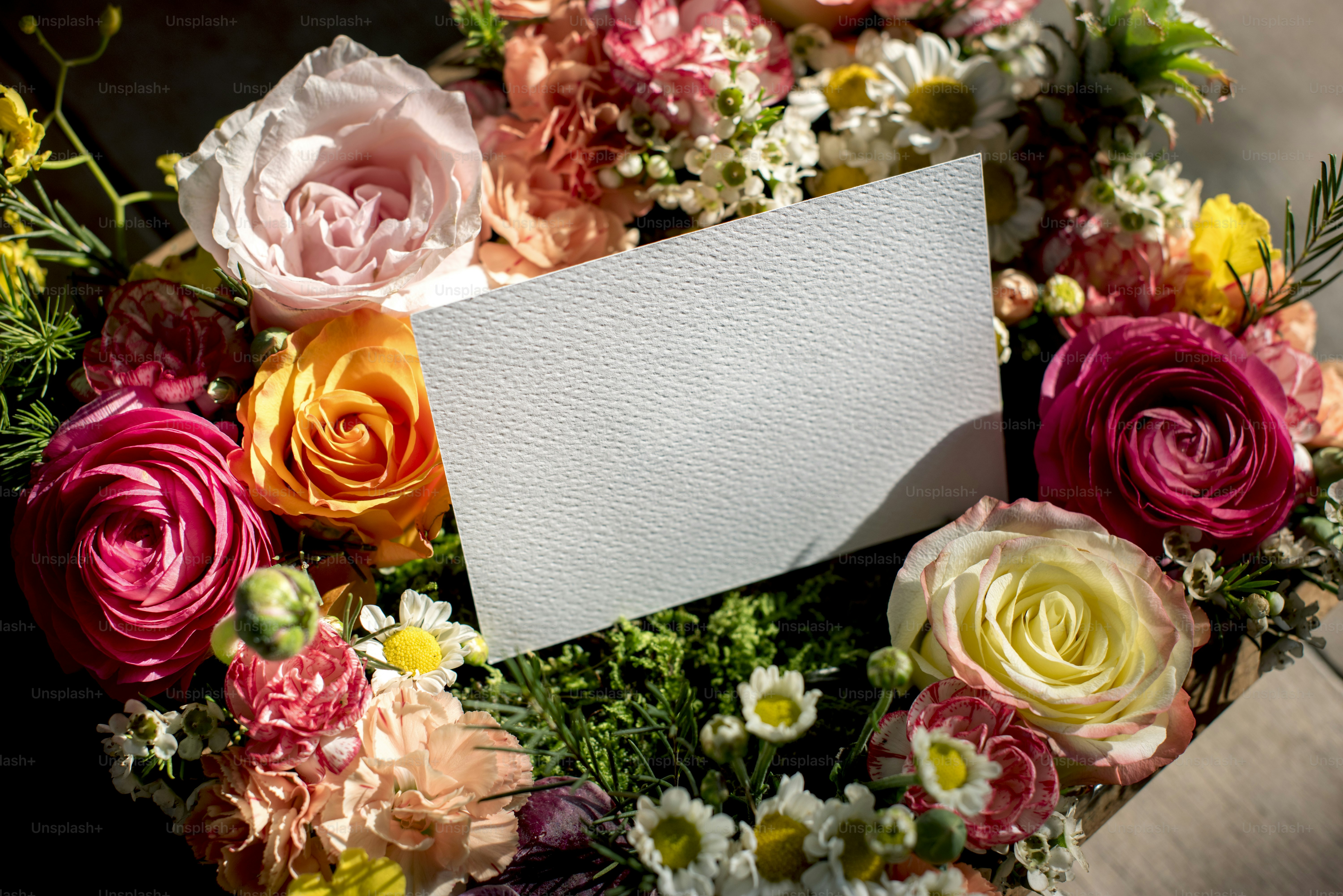 Romantic anniversary greetings written beside flowers and a thoughtful gift arrangement