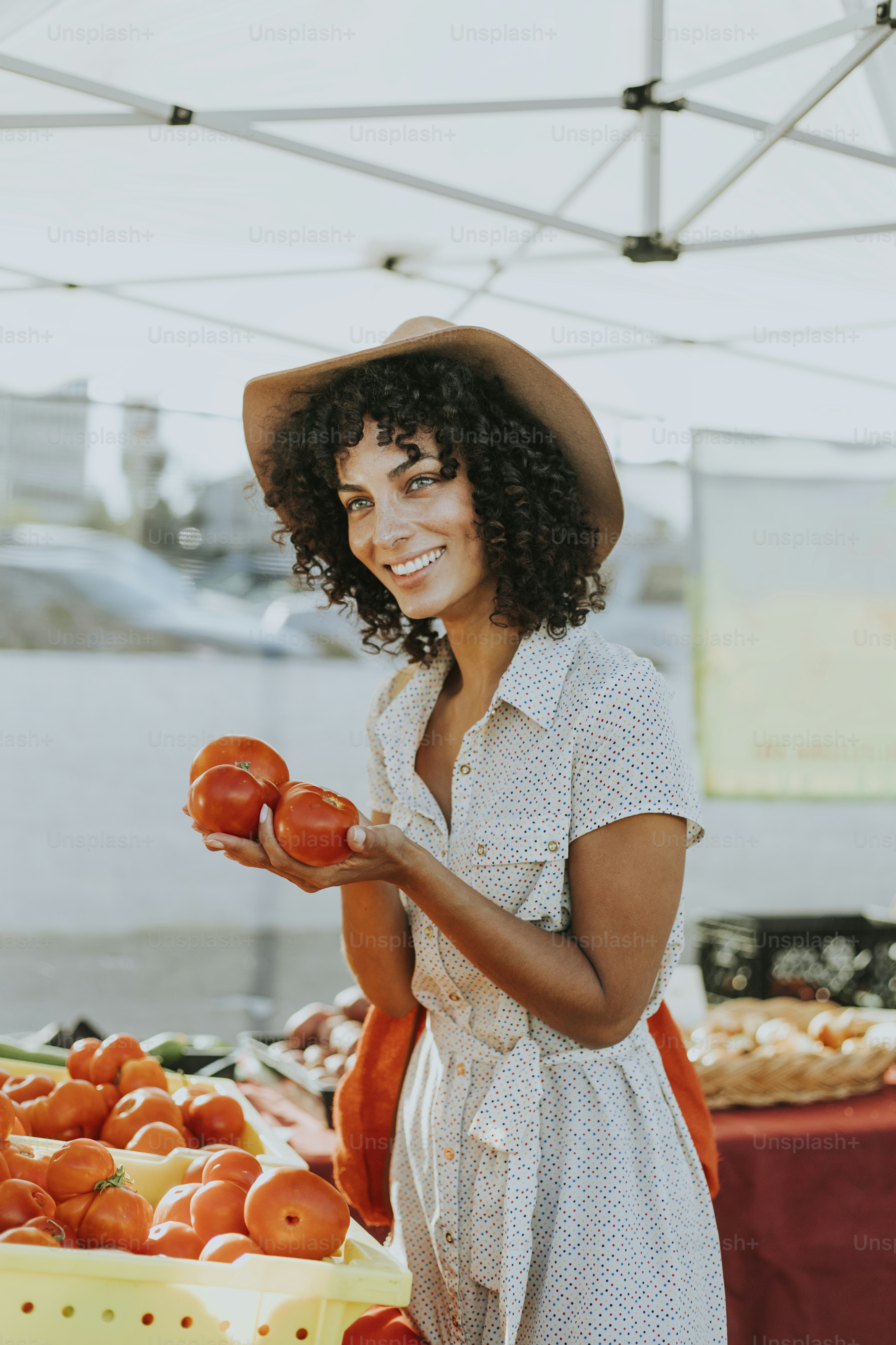 Woman buying tomatoes at a farmers market