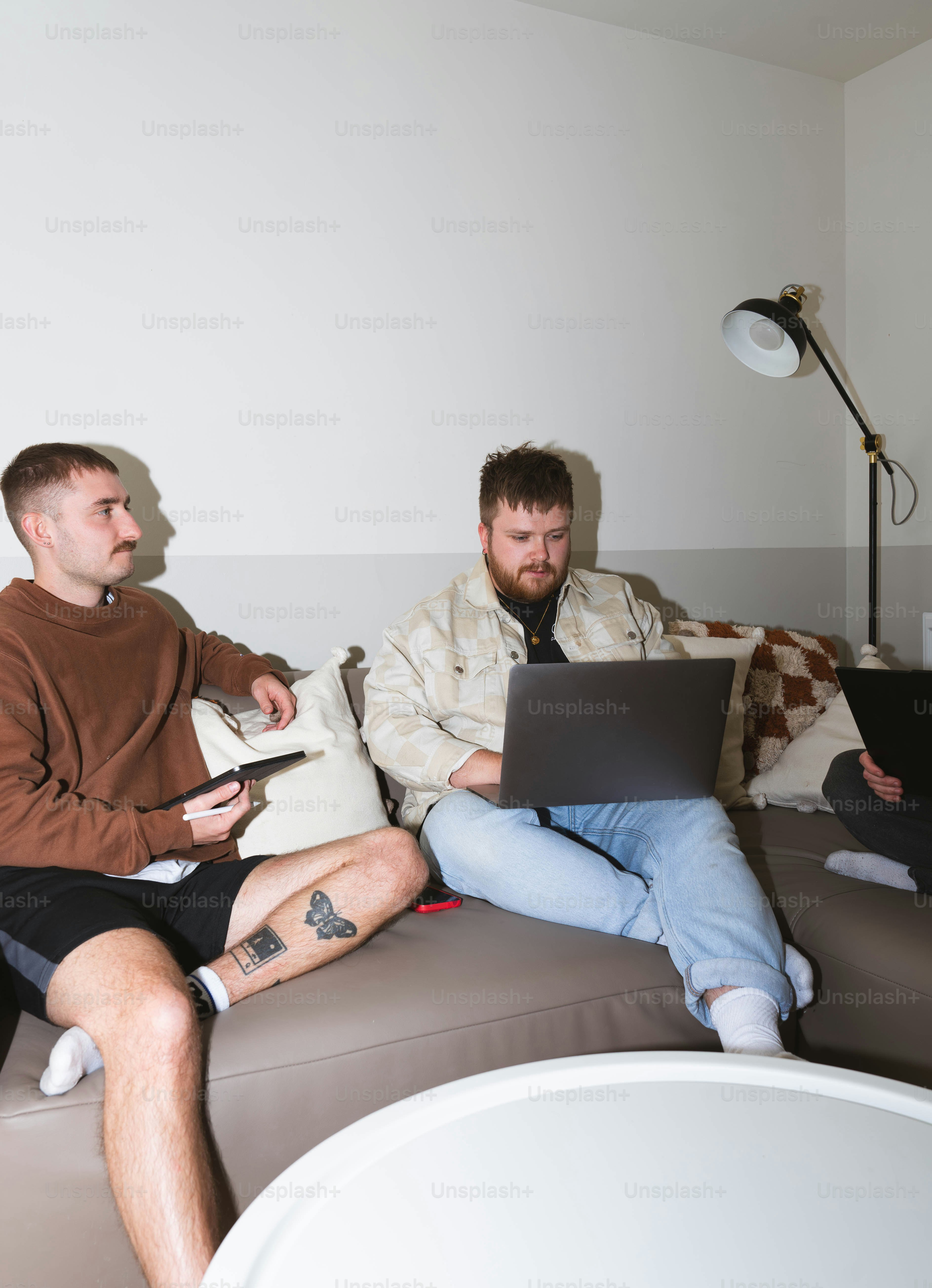 A group of men sitting on top of a couch