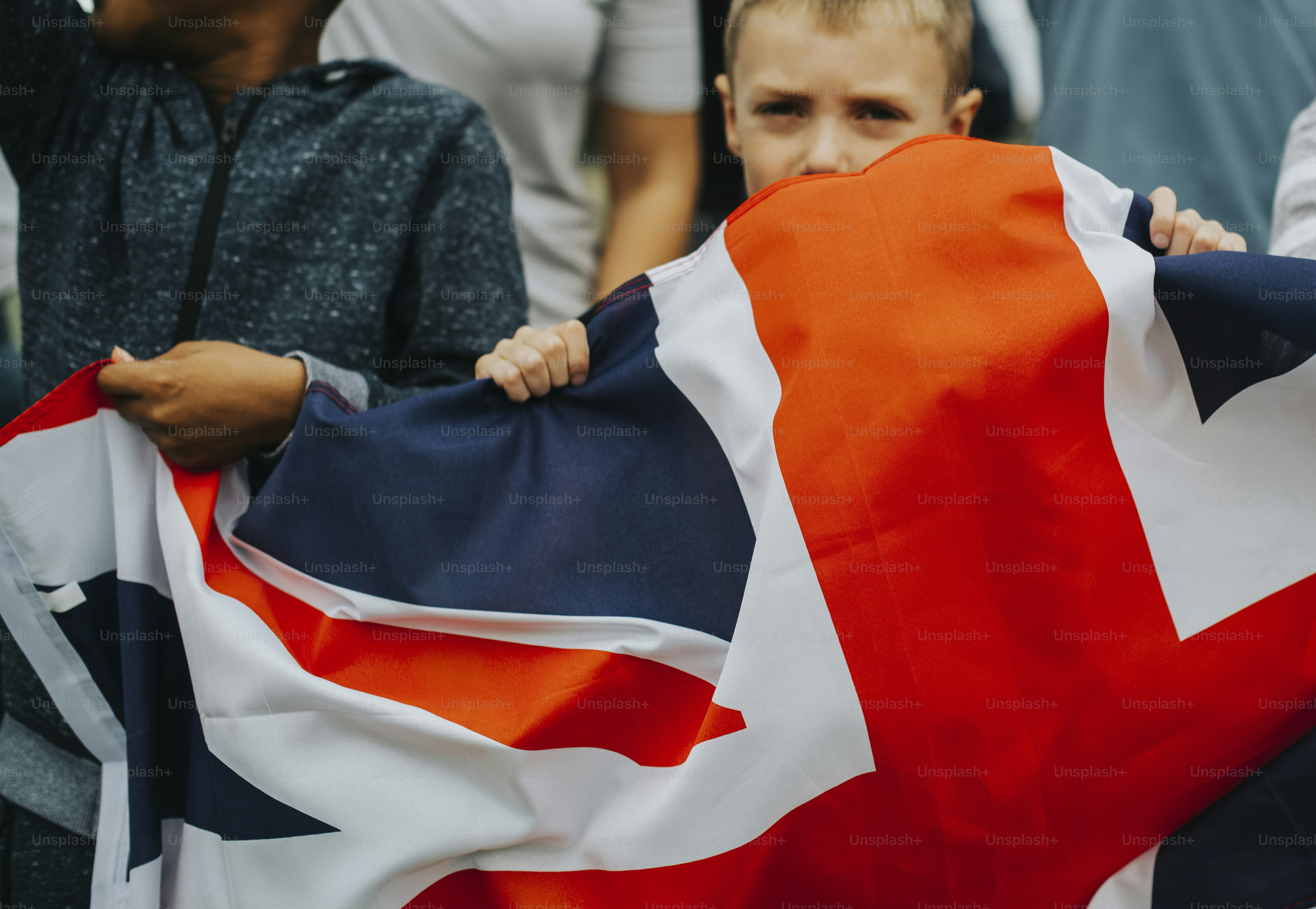 Group of diverse kids showing a UK flag in a protest photo – Black ...