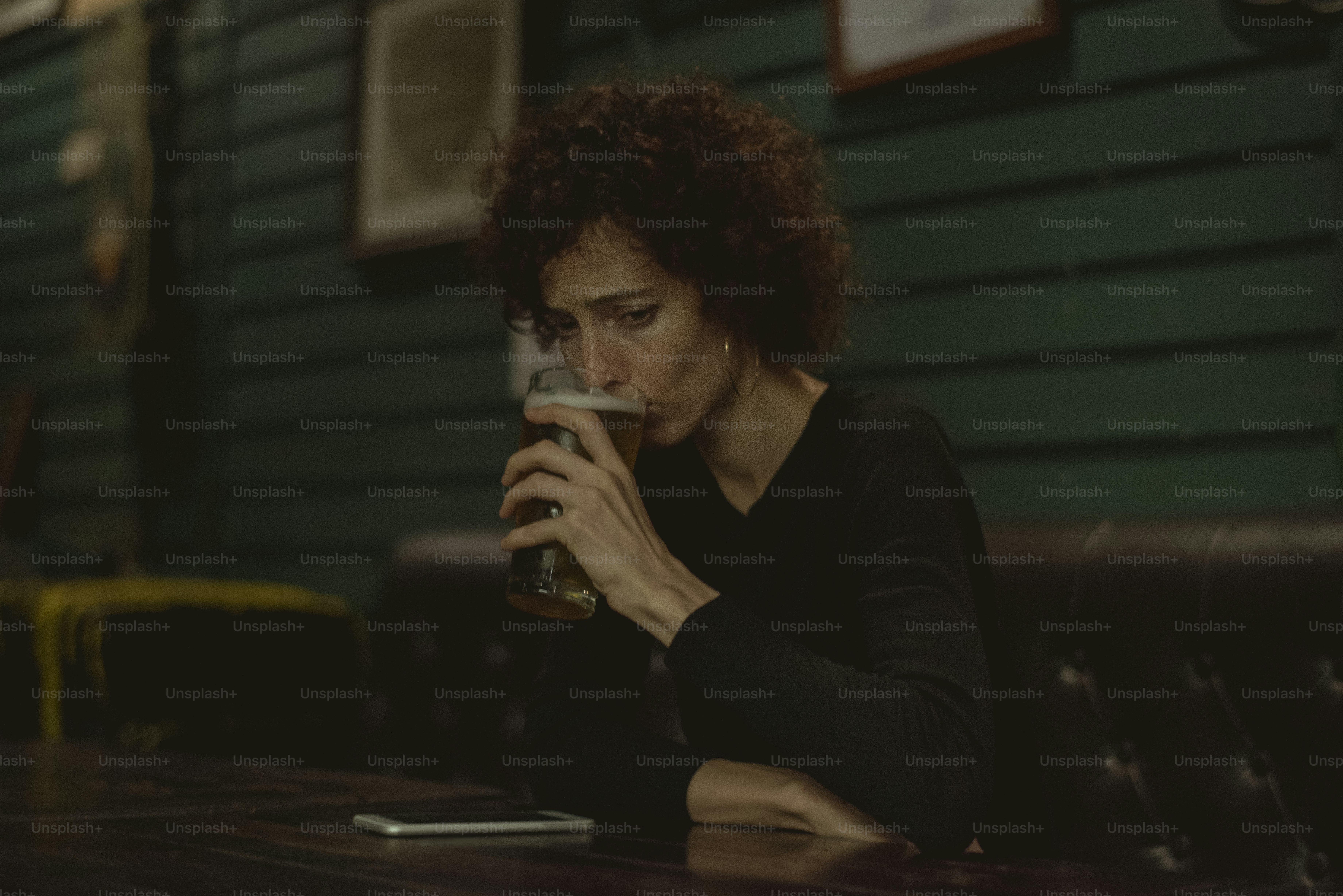 Woman having a beer at a bar