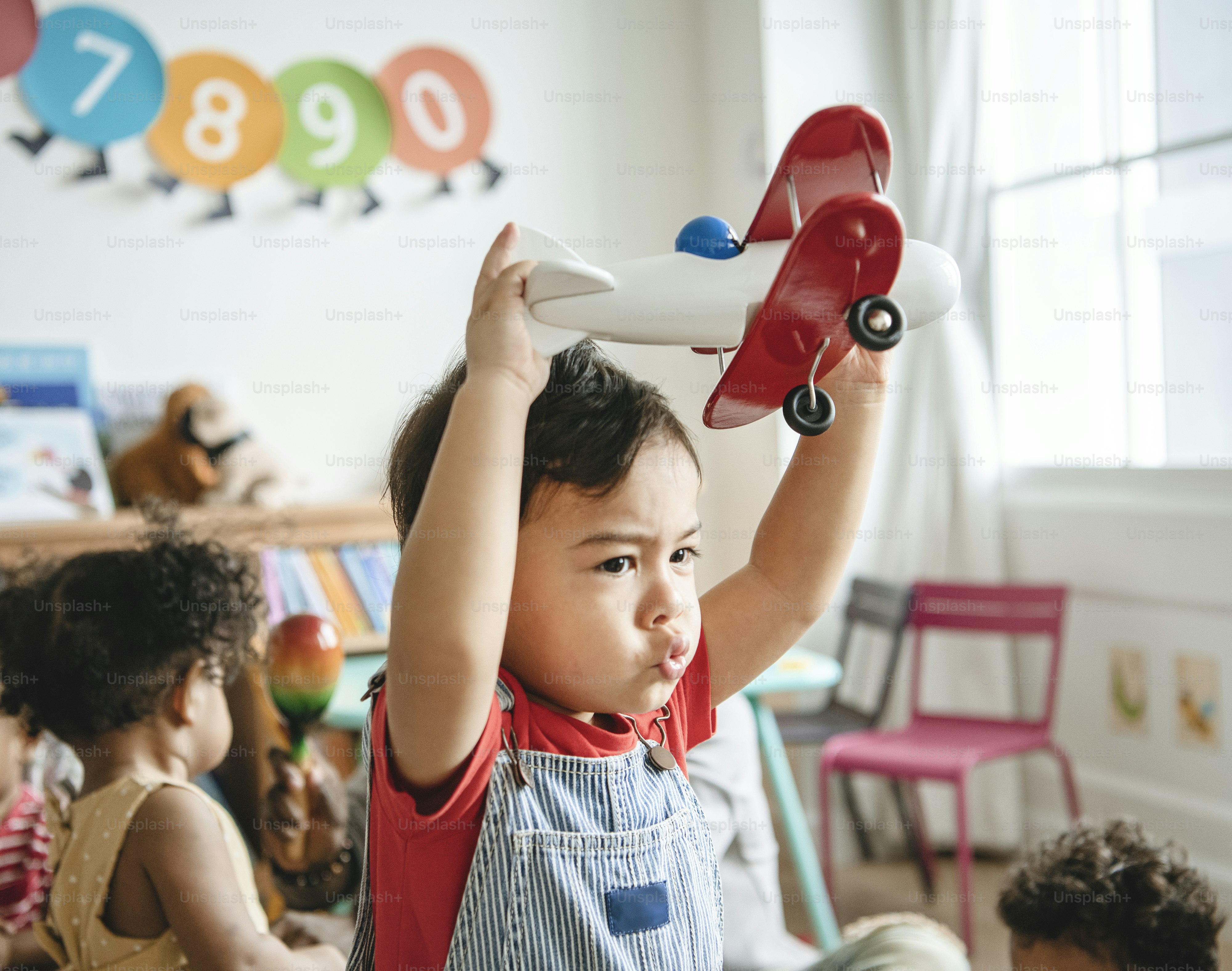 Preschooler enjoying playing with his airplane toy