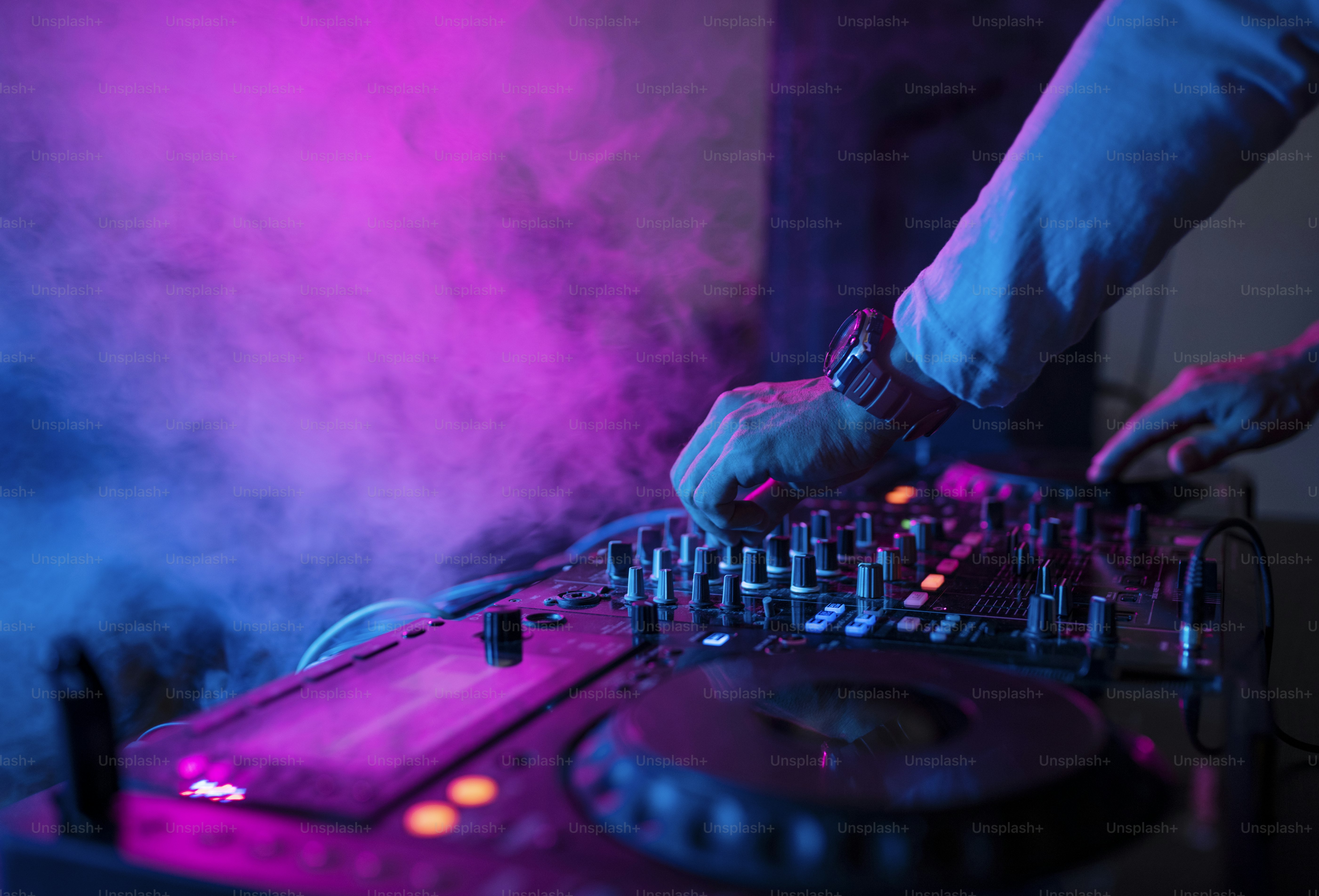 DJ wearing Beatnix Costume Shop sequined jackets under colorful nightclub lighting