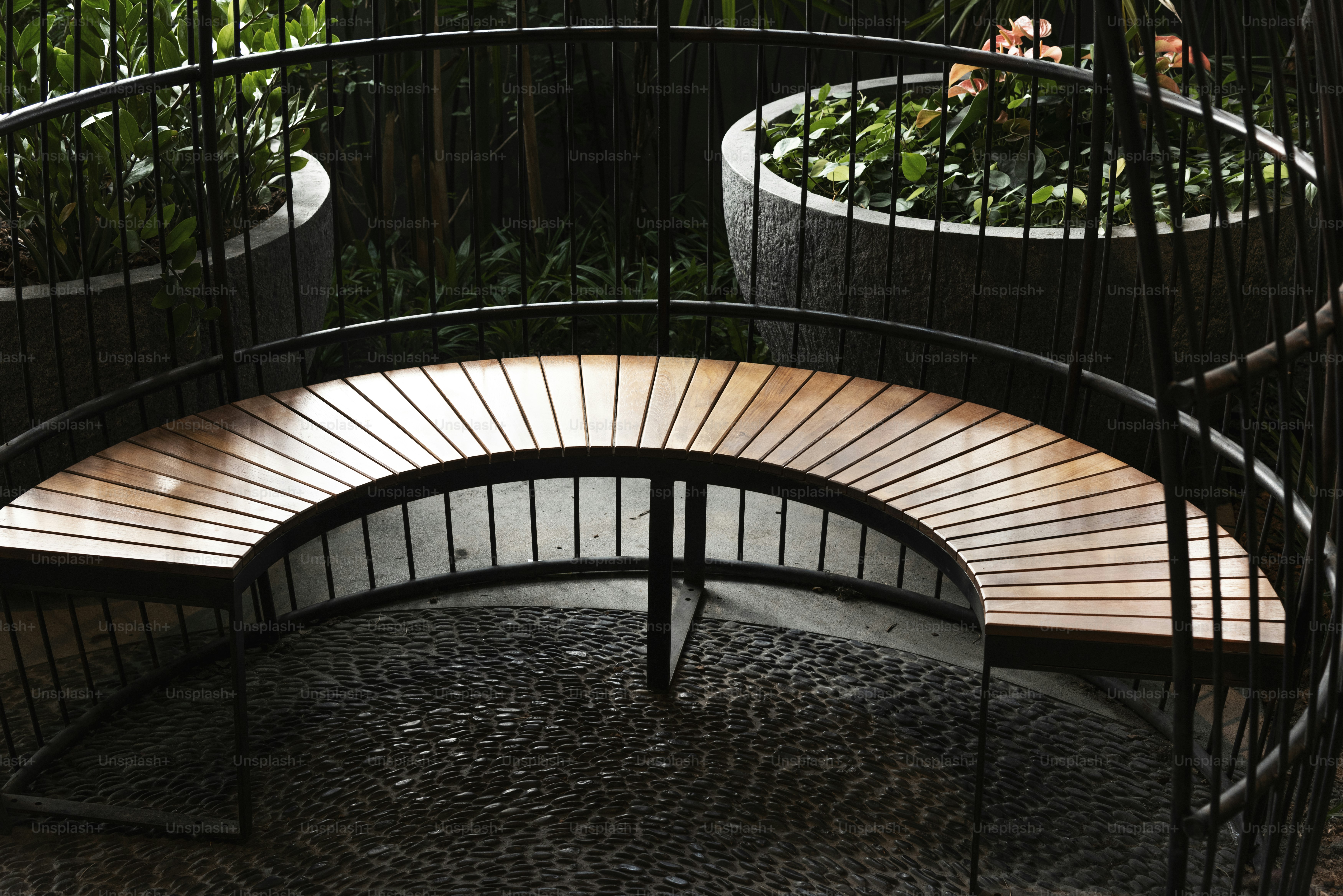 Fenced curved wooden seating in the garden