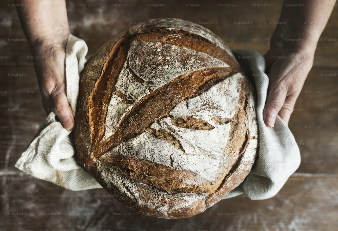 Freshly baked sourdough bread loaf on a wooden cutting board