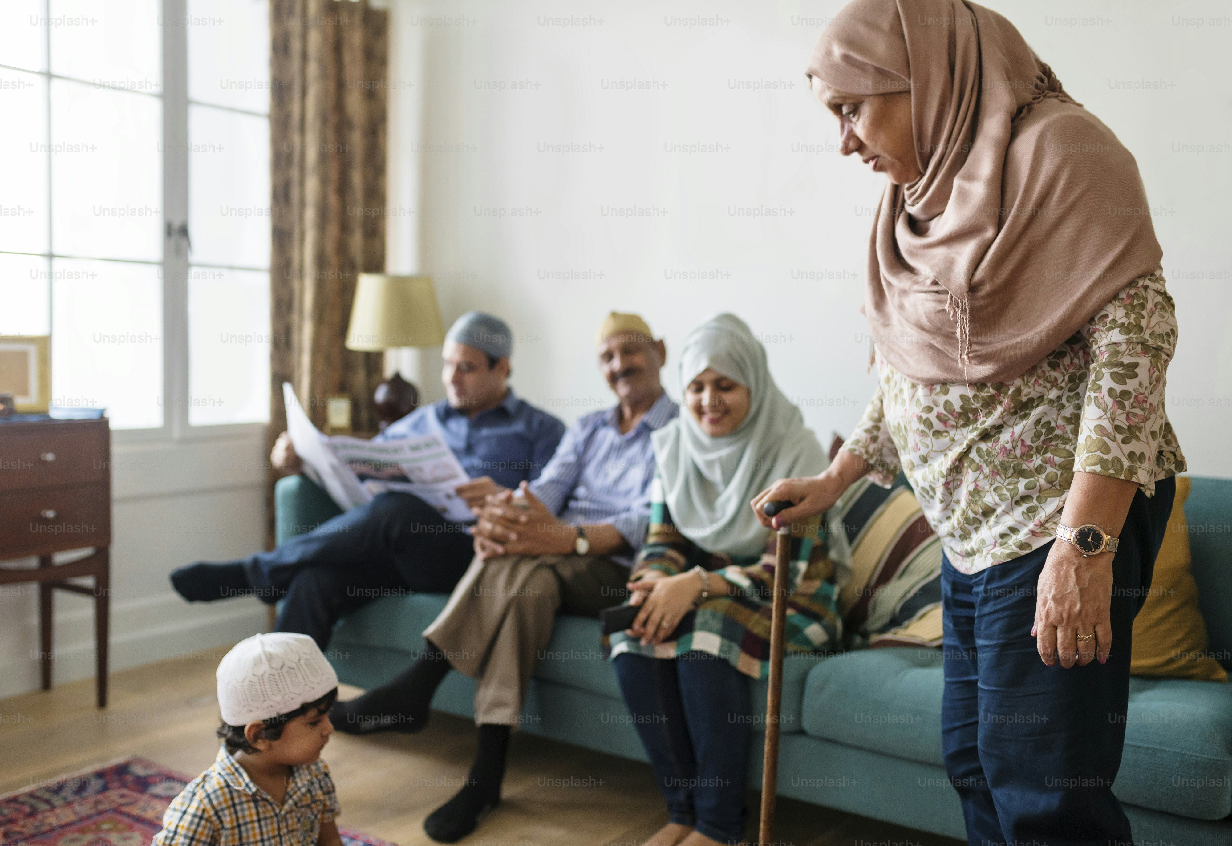 Muslim family relaxing in the home ***The newspaper our own generic designs. They do not infringe on any copyrighted designs.