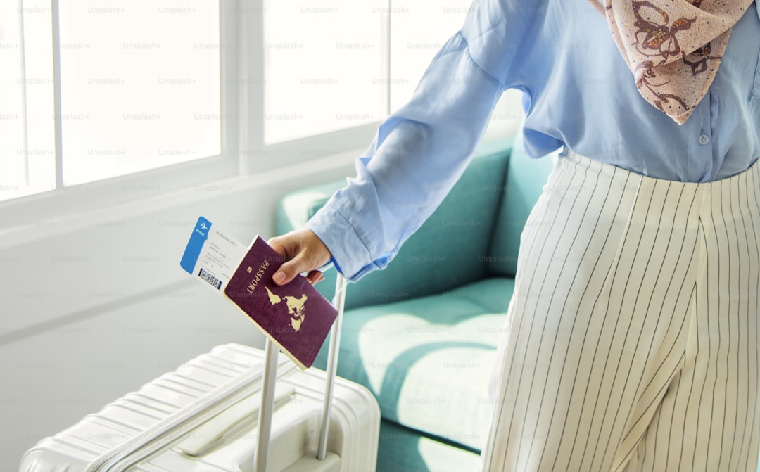 Islamic woman preparing to travel *These passport and plane ticket are our own generic designs. They do not infringe on 