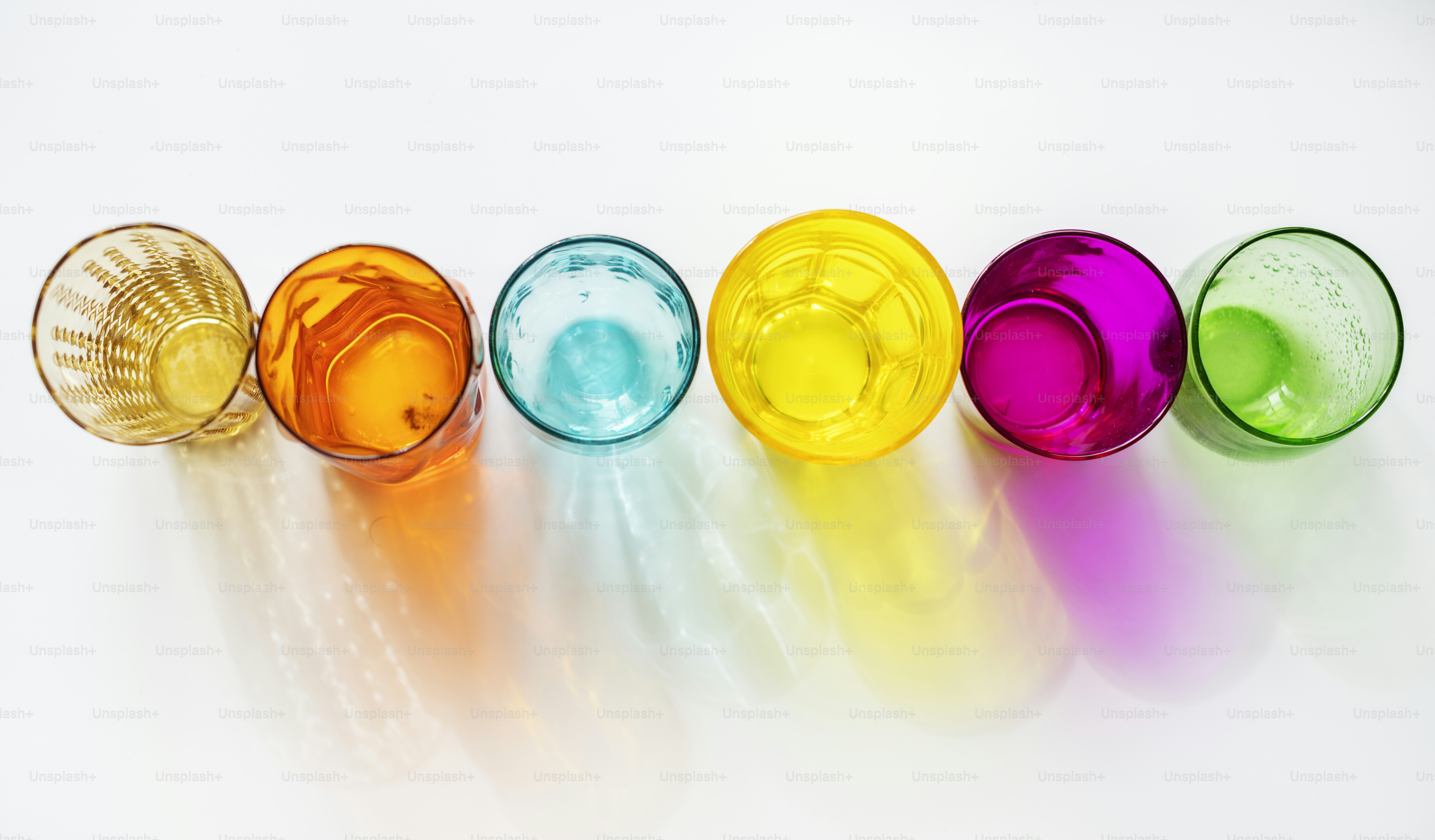 Colorful glasses on white background