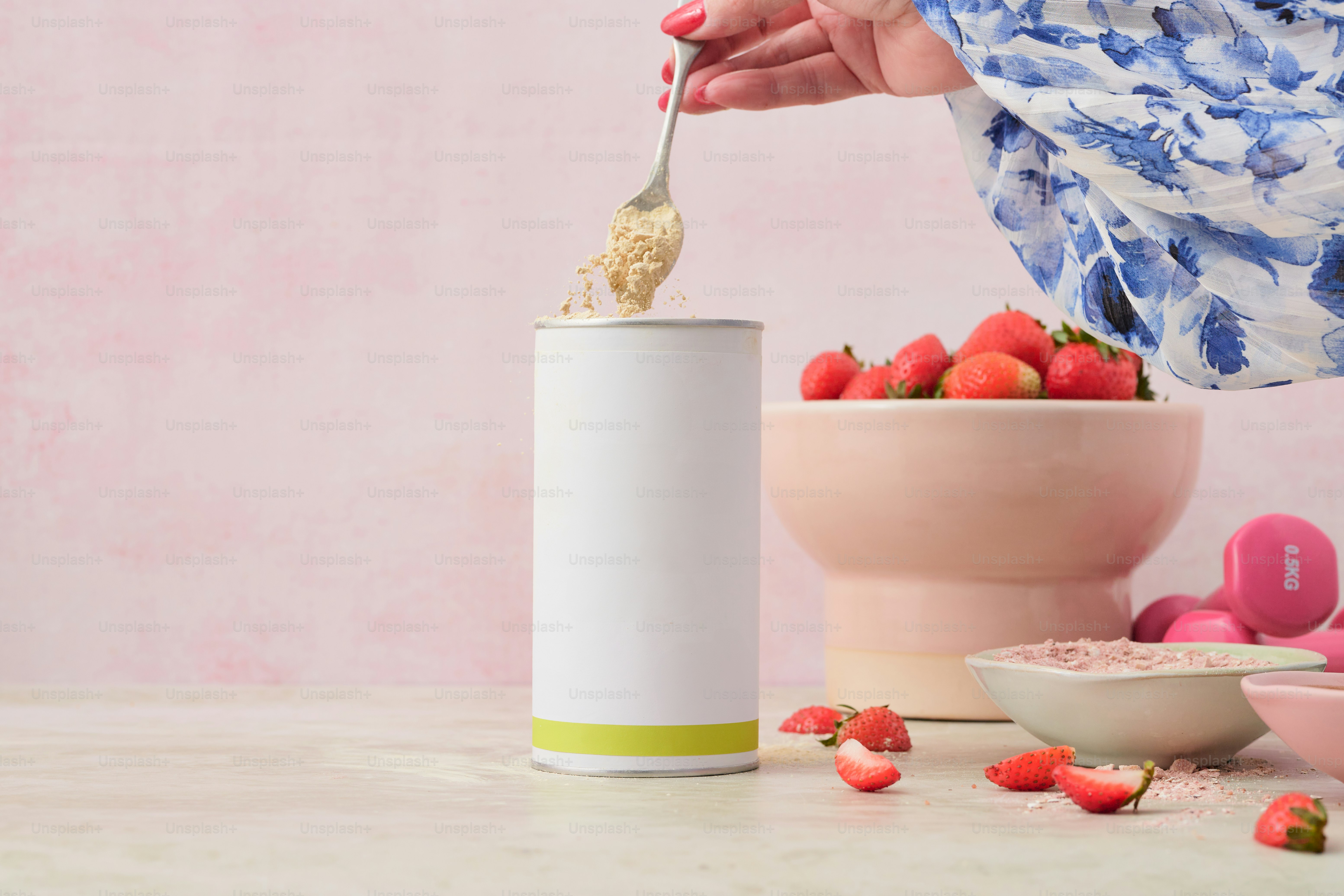 A woman is eating strawberries out of a cup