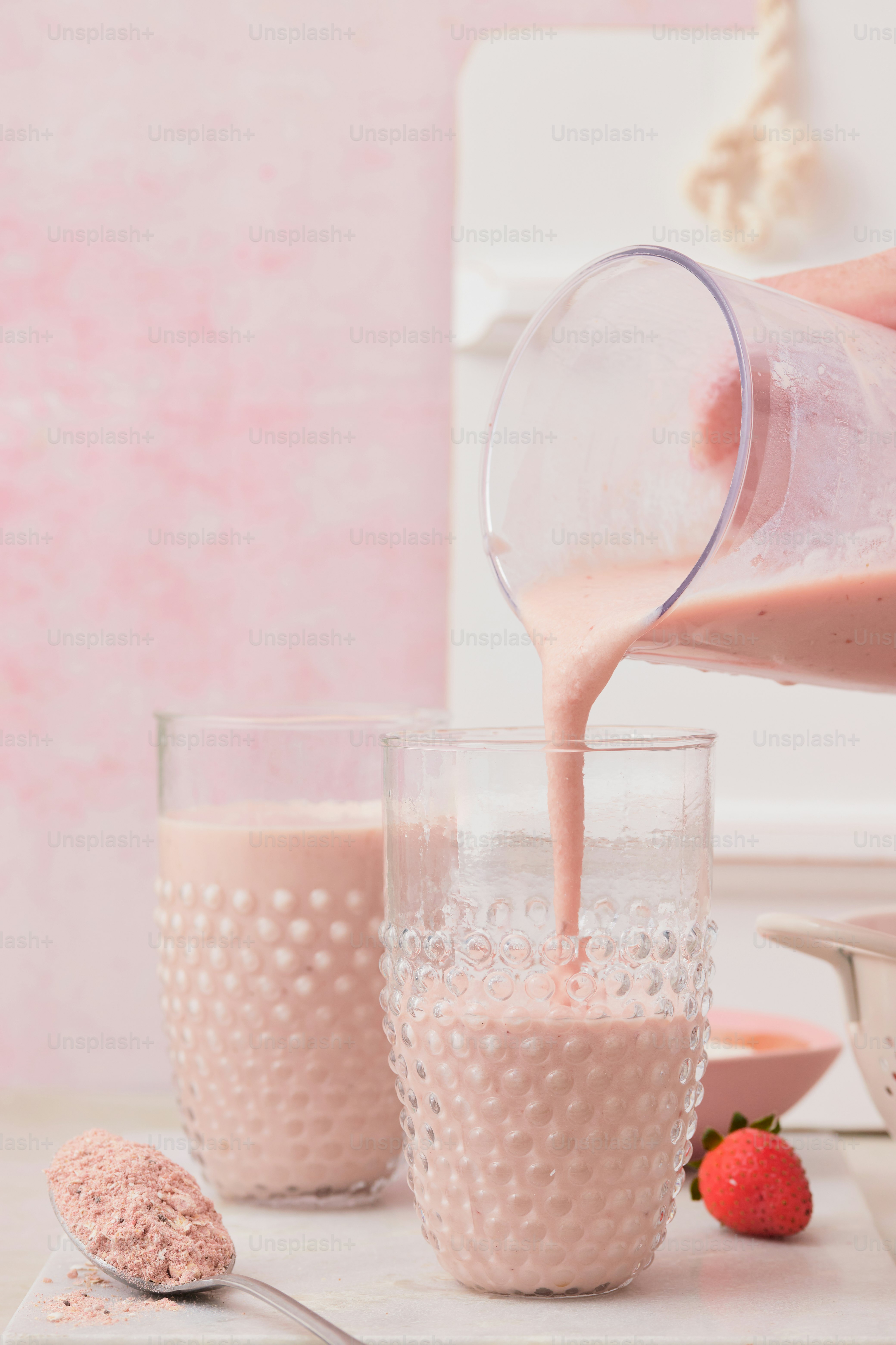 A person pouring a drink into a glass