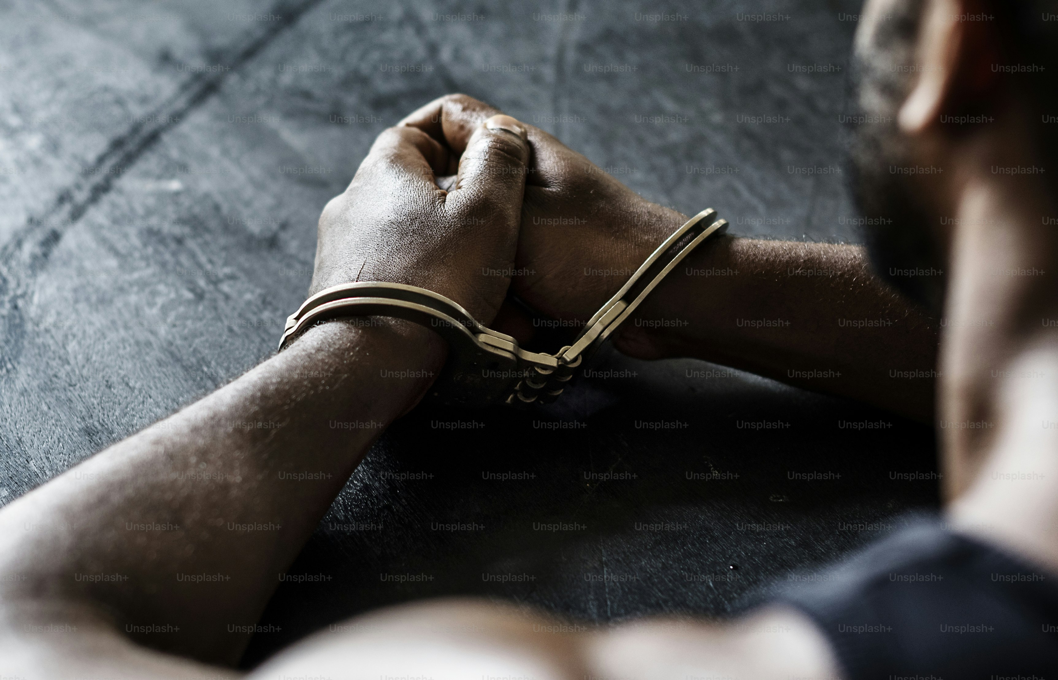 Arrested man with handcuffs on wrists