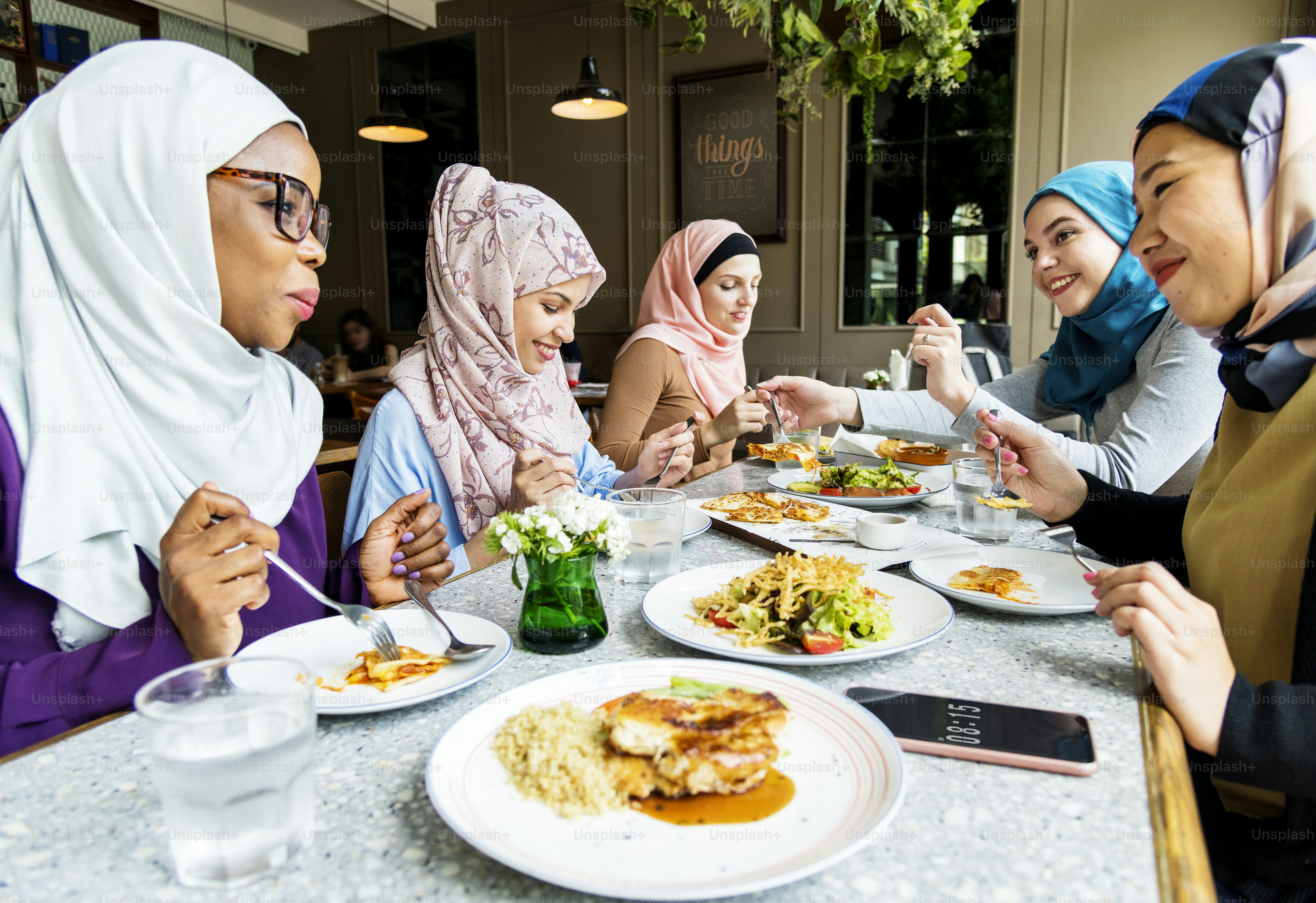 Islamic women friends dining together with happiness