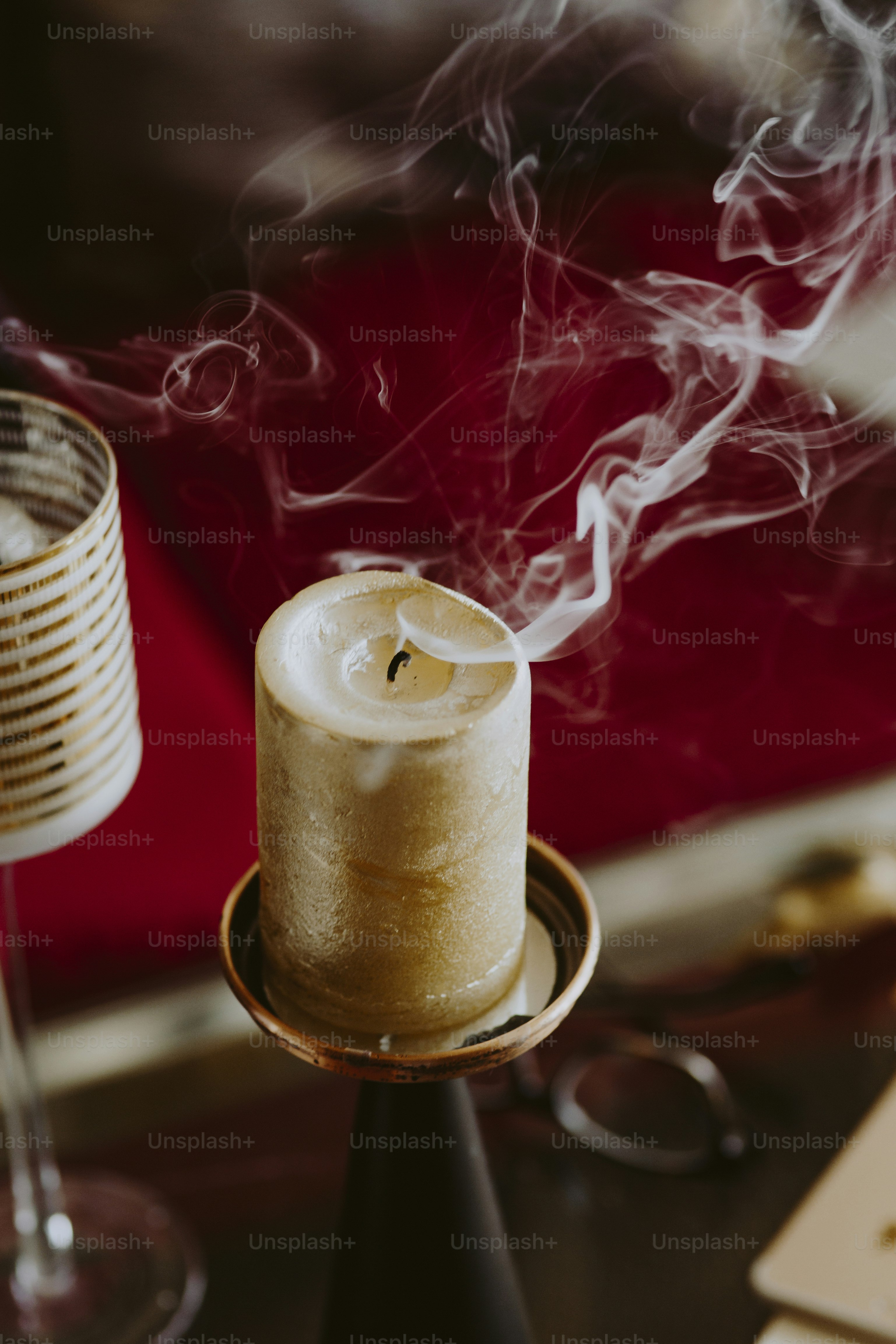 Blown out bronze candle on a candlestick