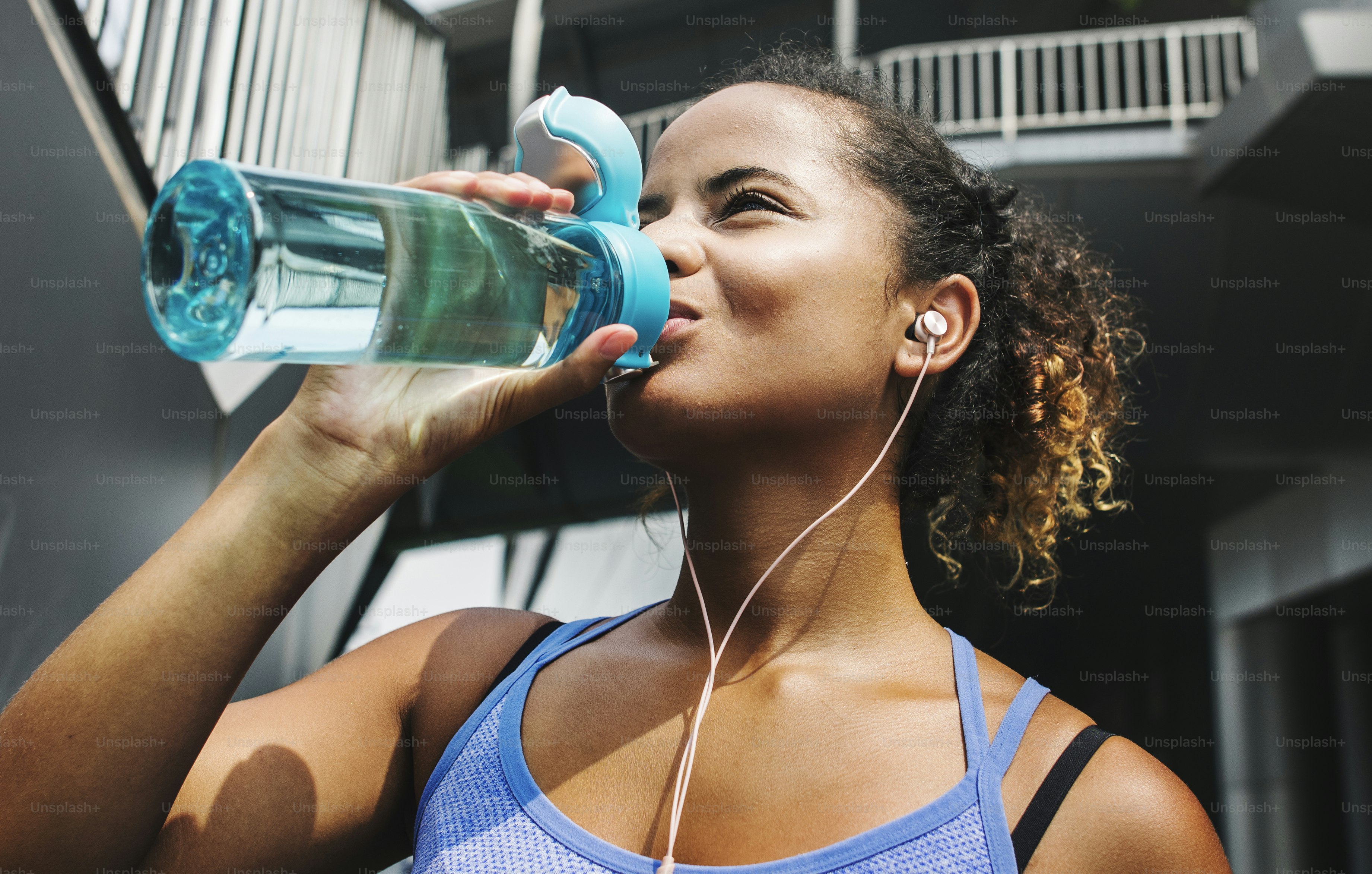 Healthy woman exercising while using technology