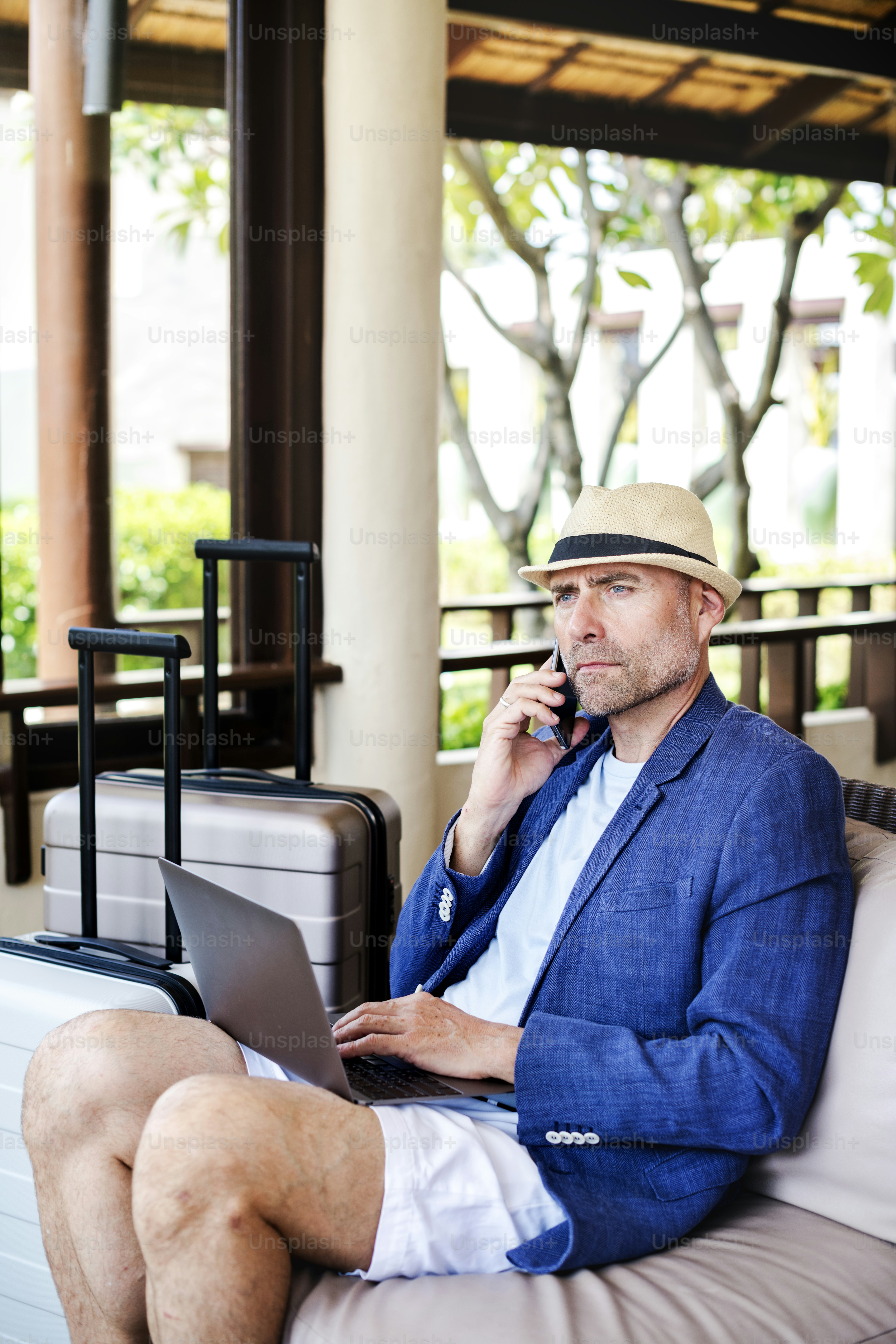 Senior man making on a call in reception area