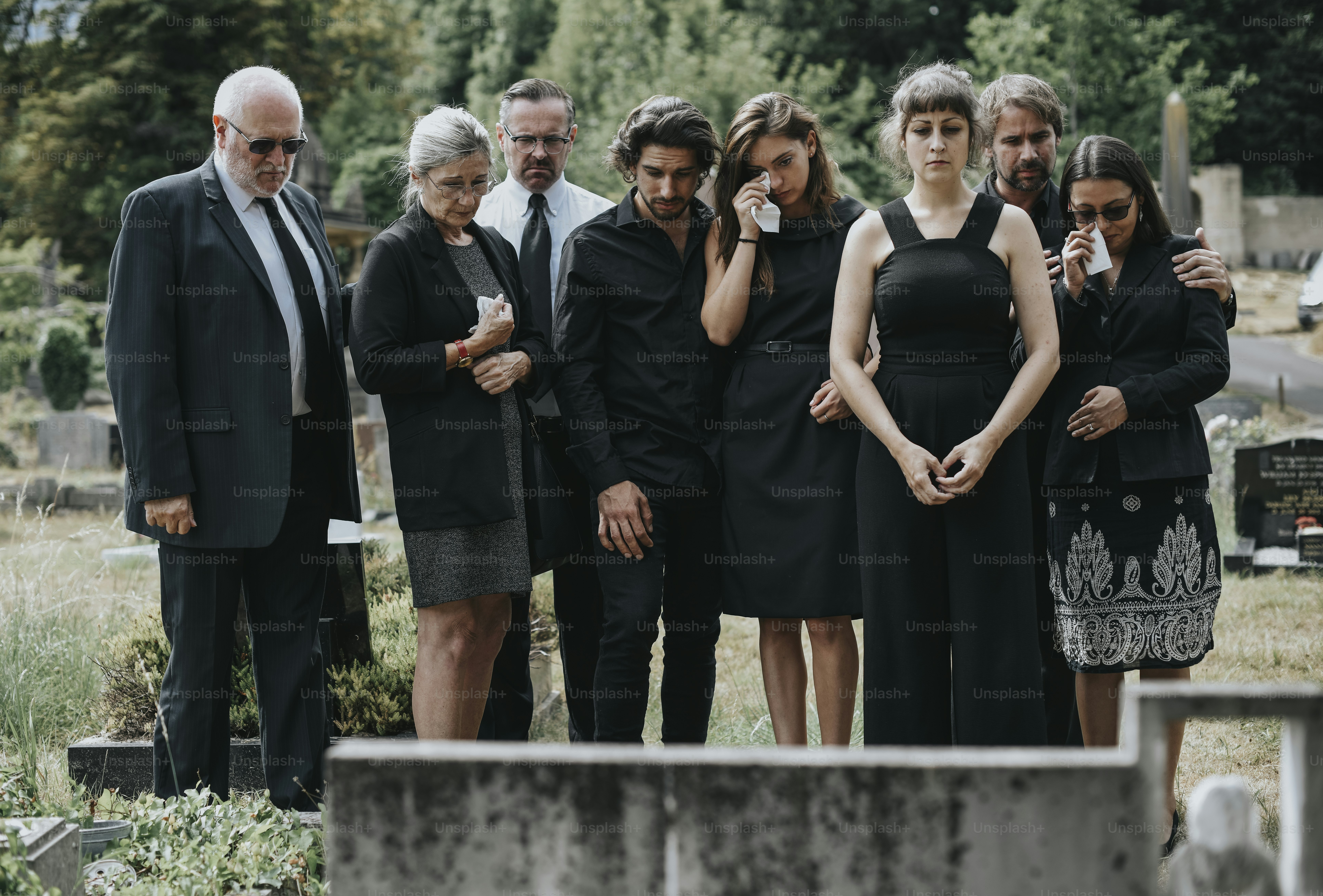Family giving their last goodbyes at the cemetery