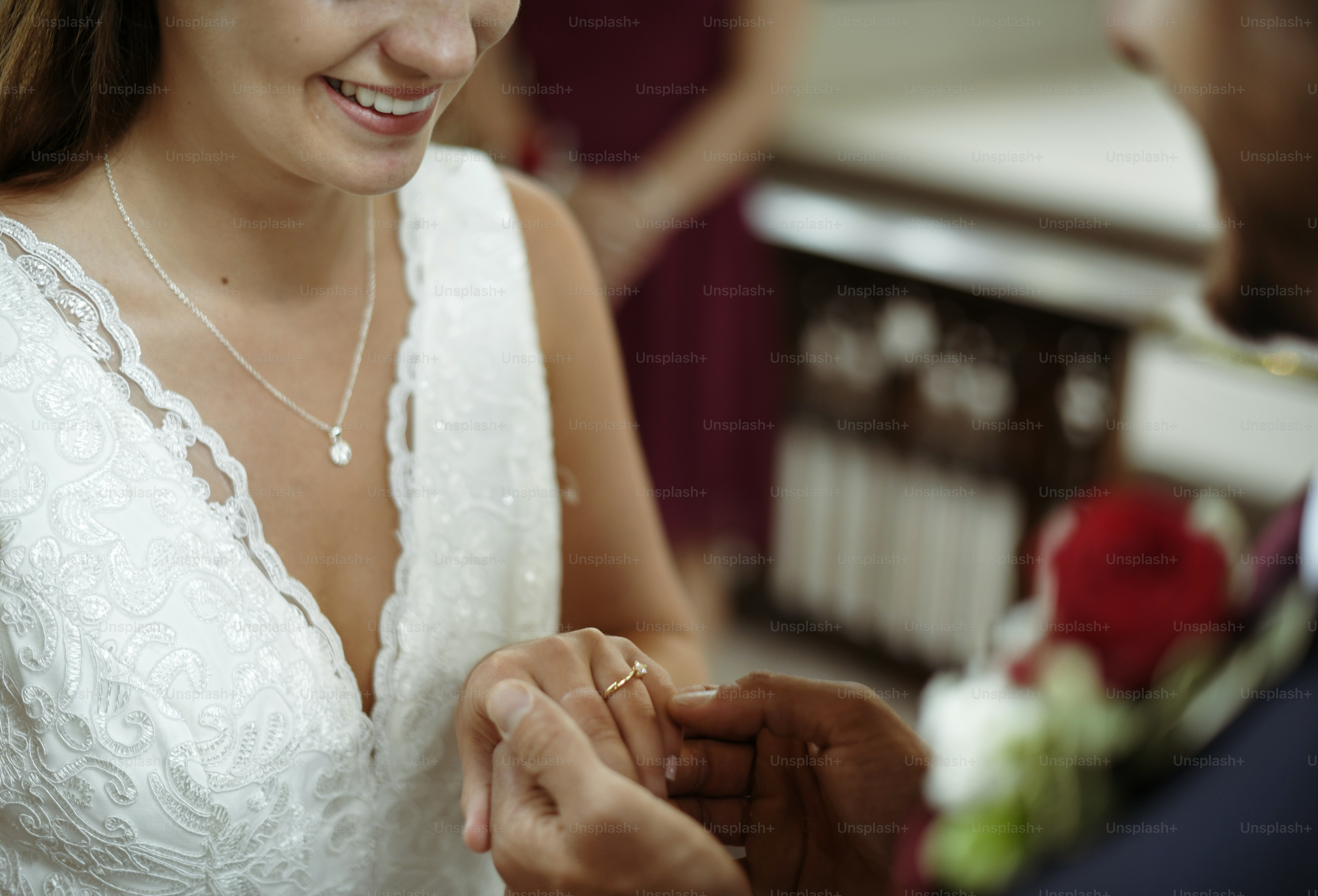 Groom putting on the wedding ring on his bride