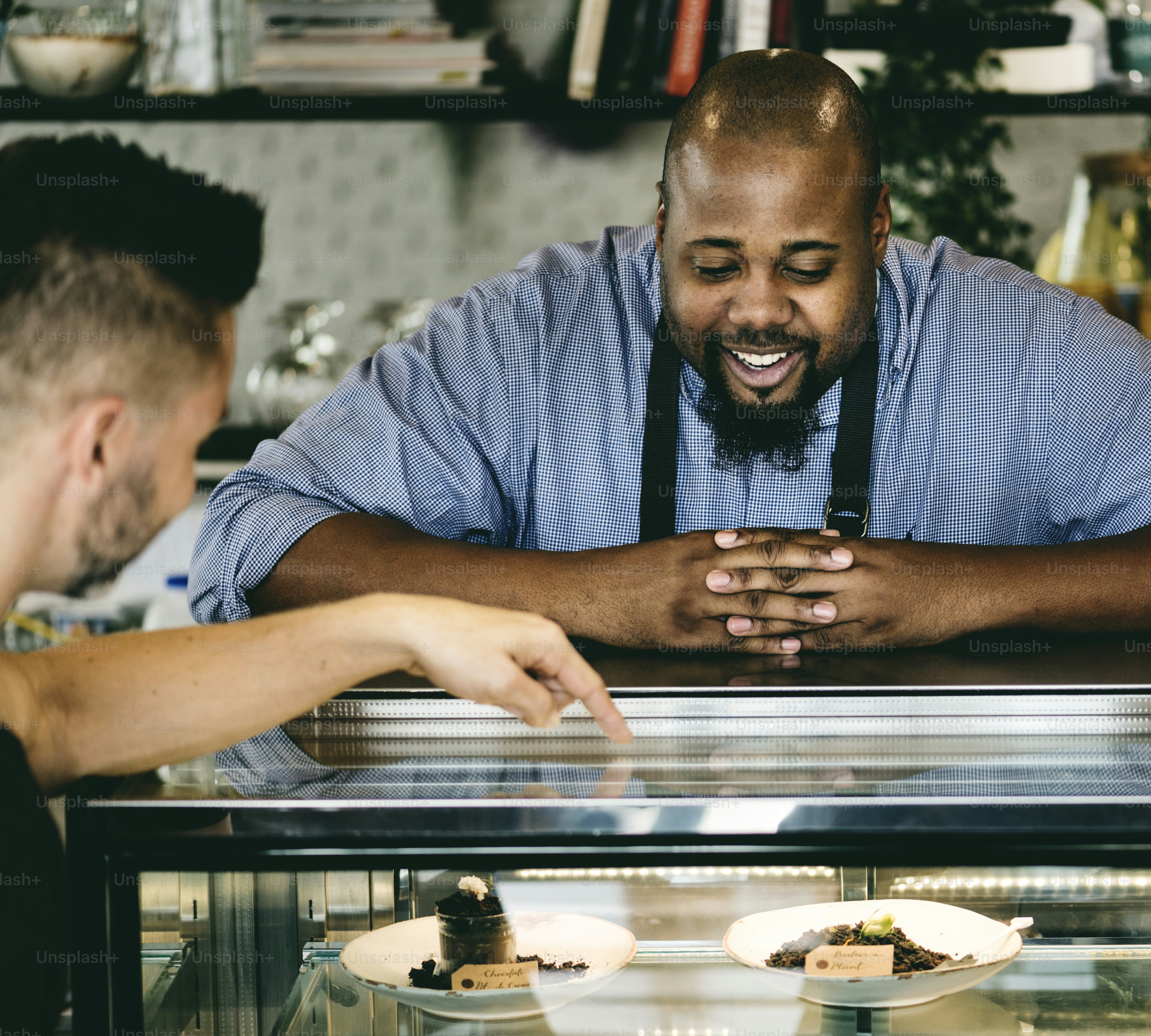 Customers choosing cake at the display fridge