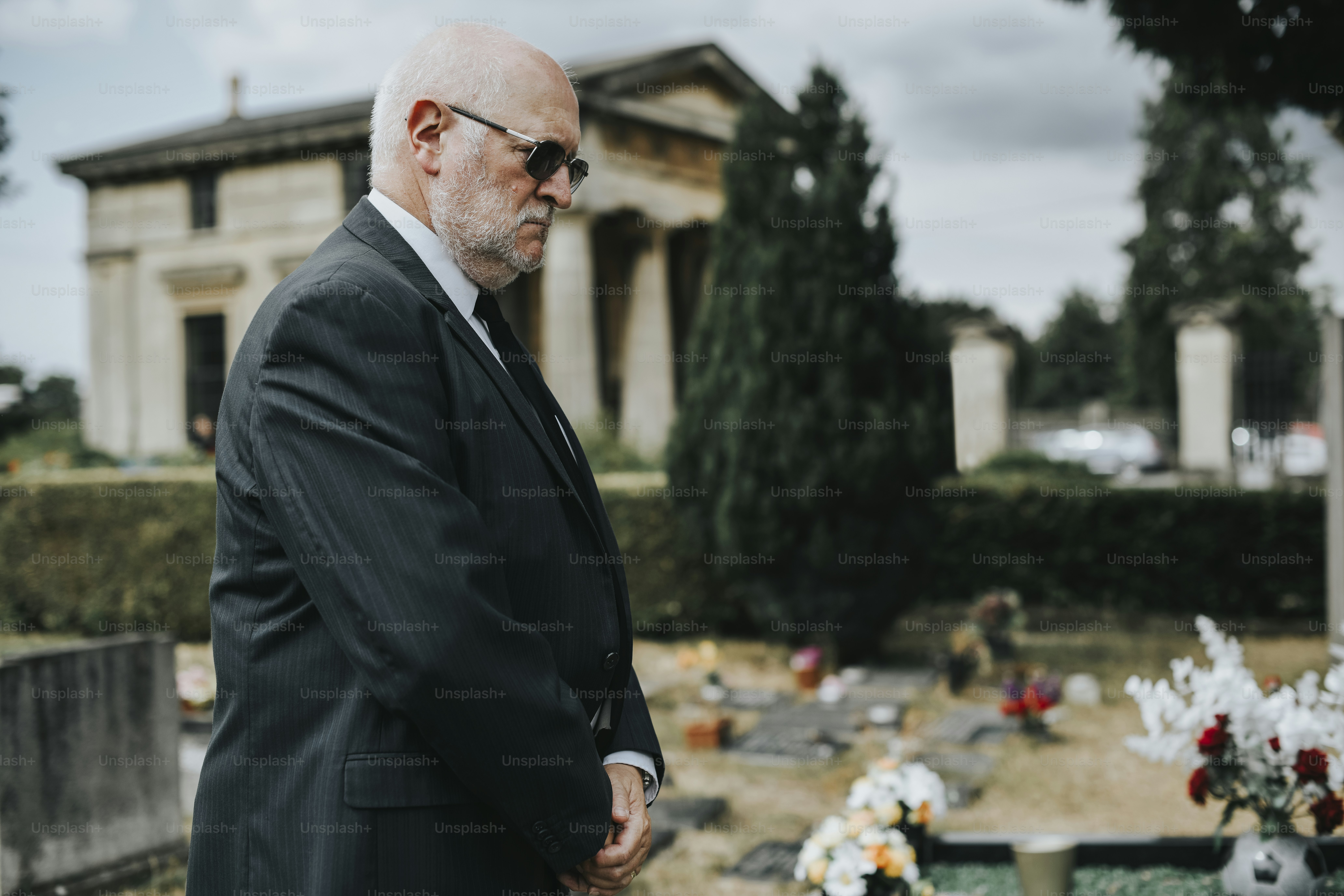 Lonely widower mourning at the graveyard