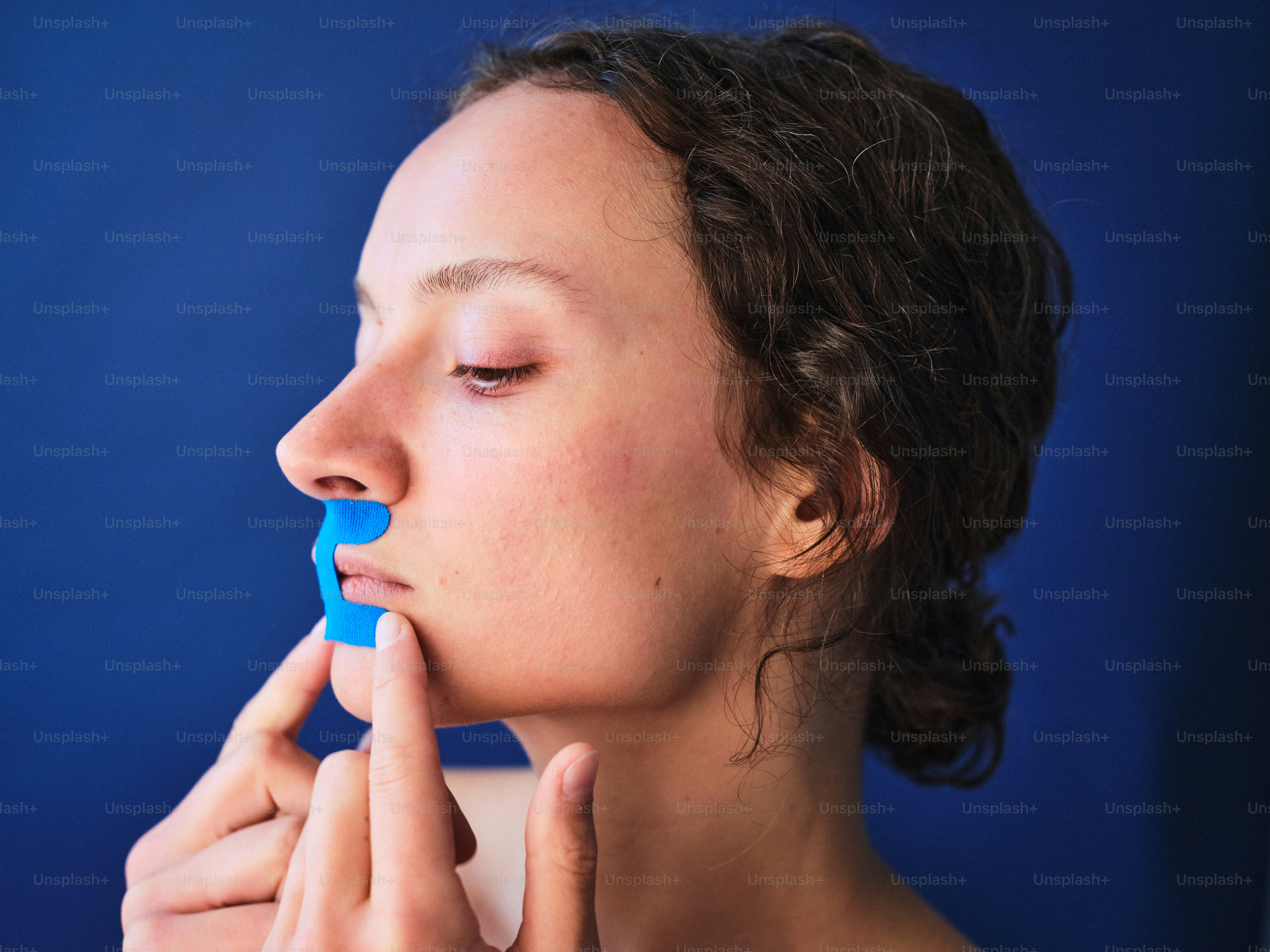 A woman with a toothbrush in her mouth