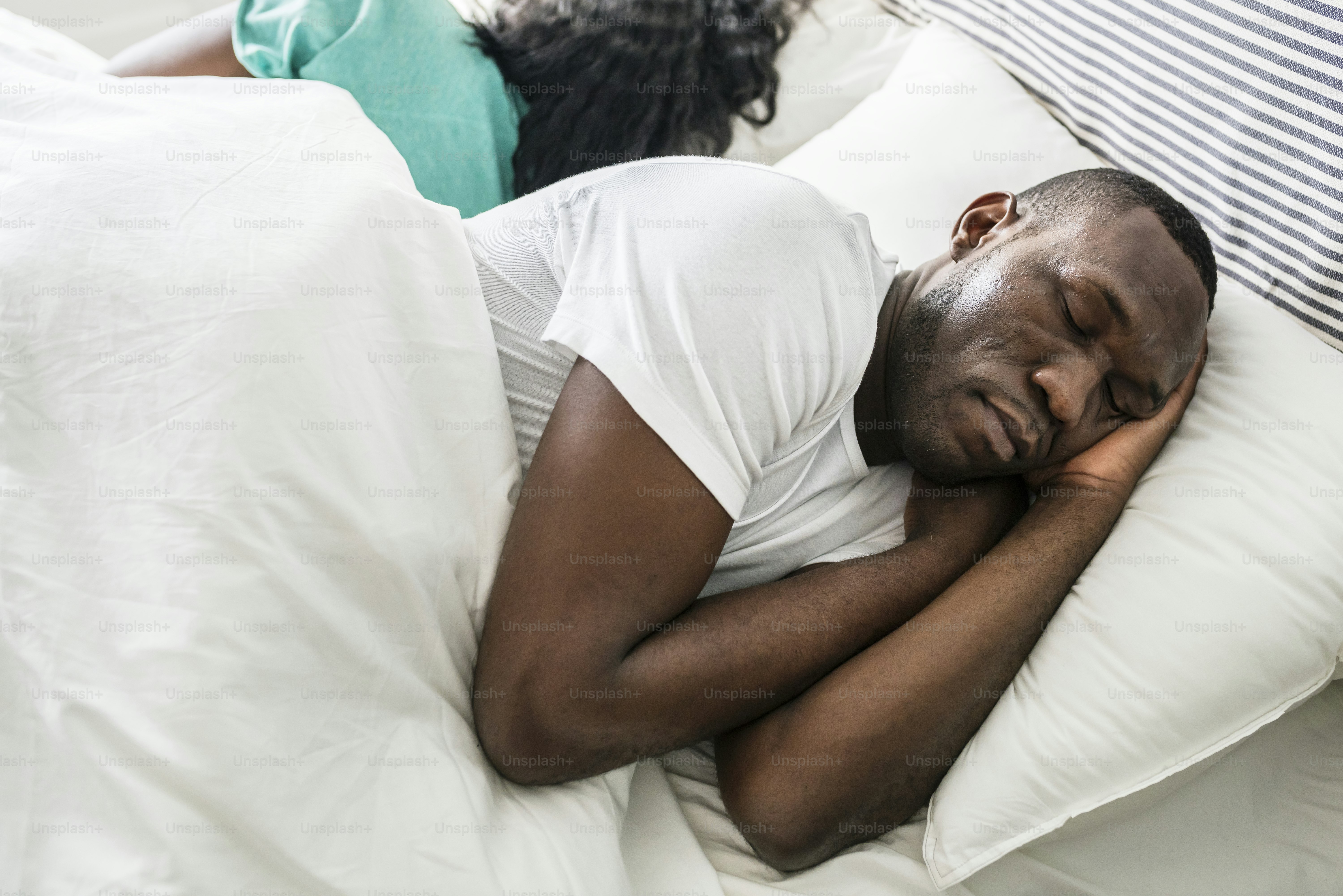 Adult practicing back sleeping with proper pillow support for neutral spine alignment.