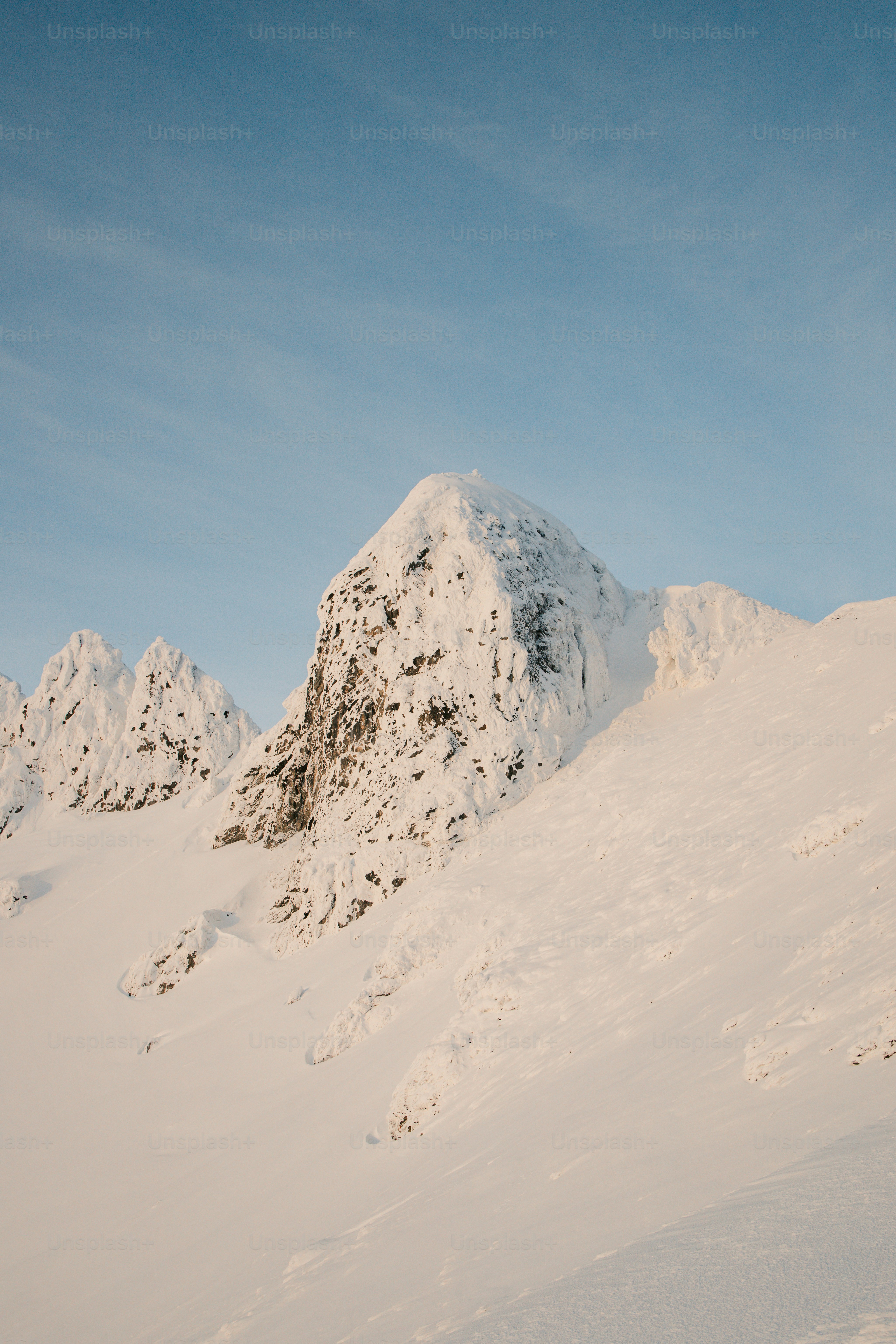 A man riding skis down the side of a snow covered slope