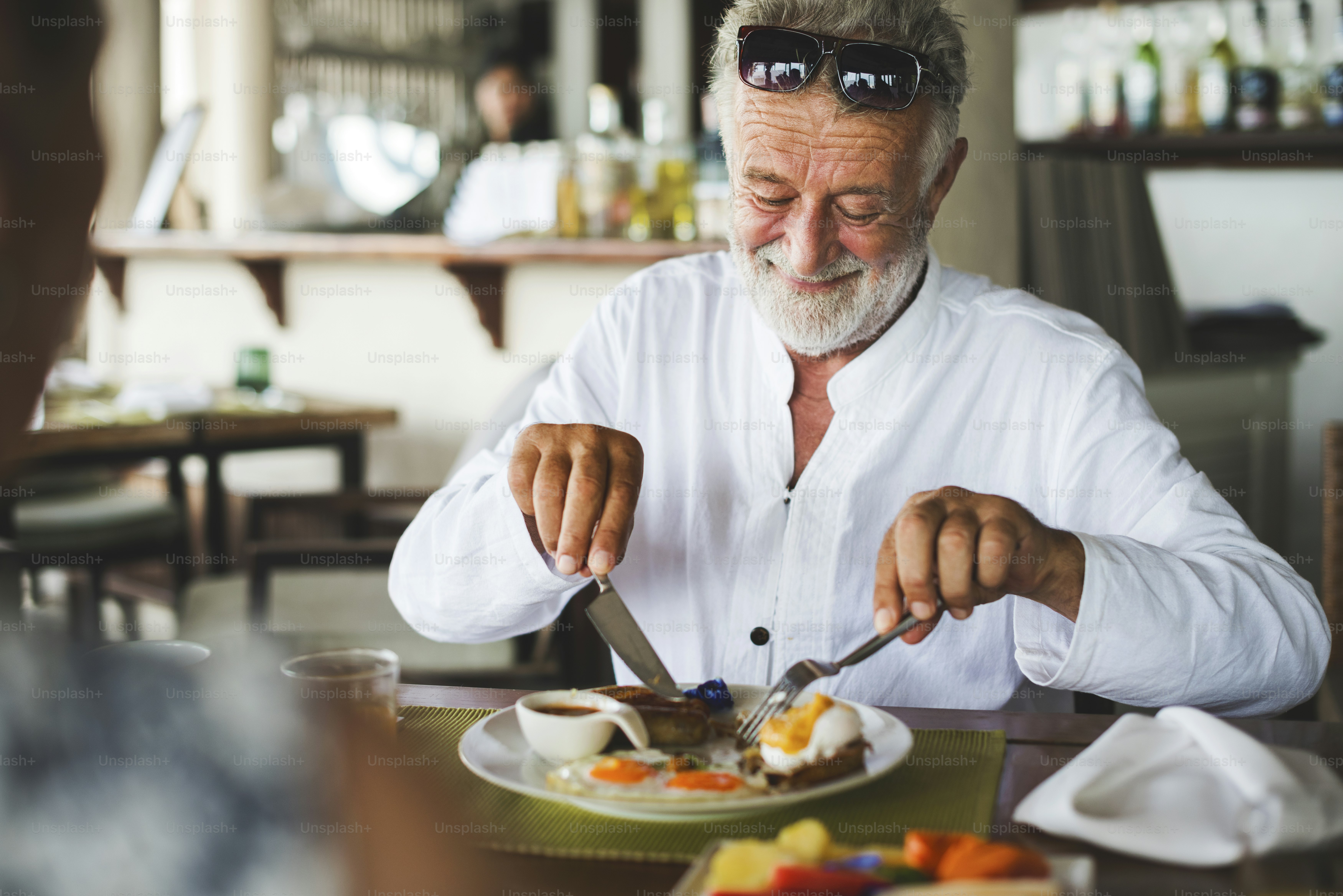 Mature man eating breakfast at hotel