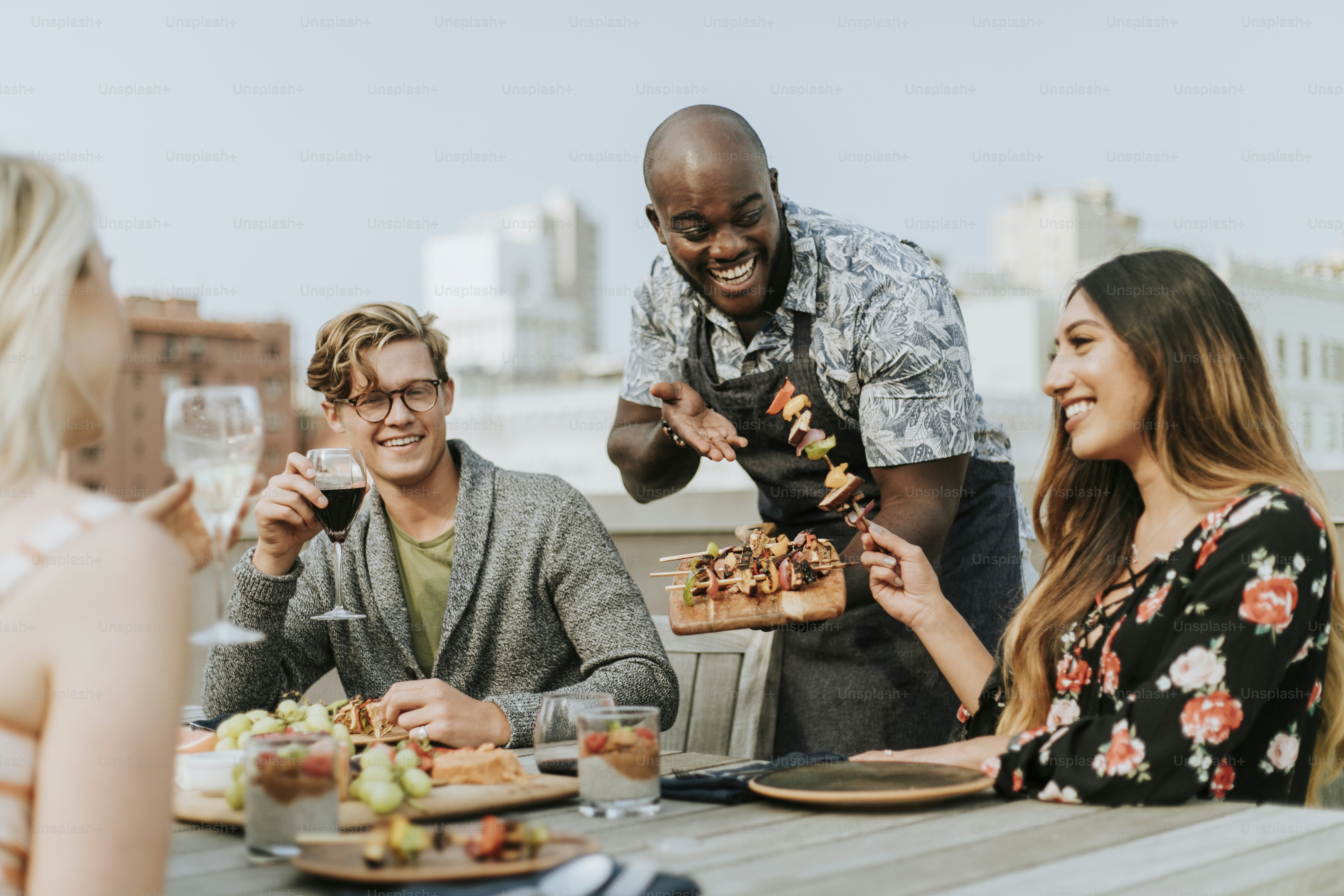 Cheerful chef serving grilled vegan barbeque skewers