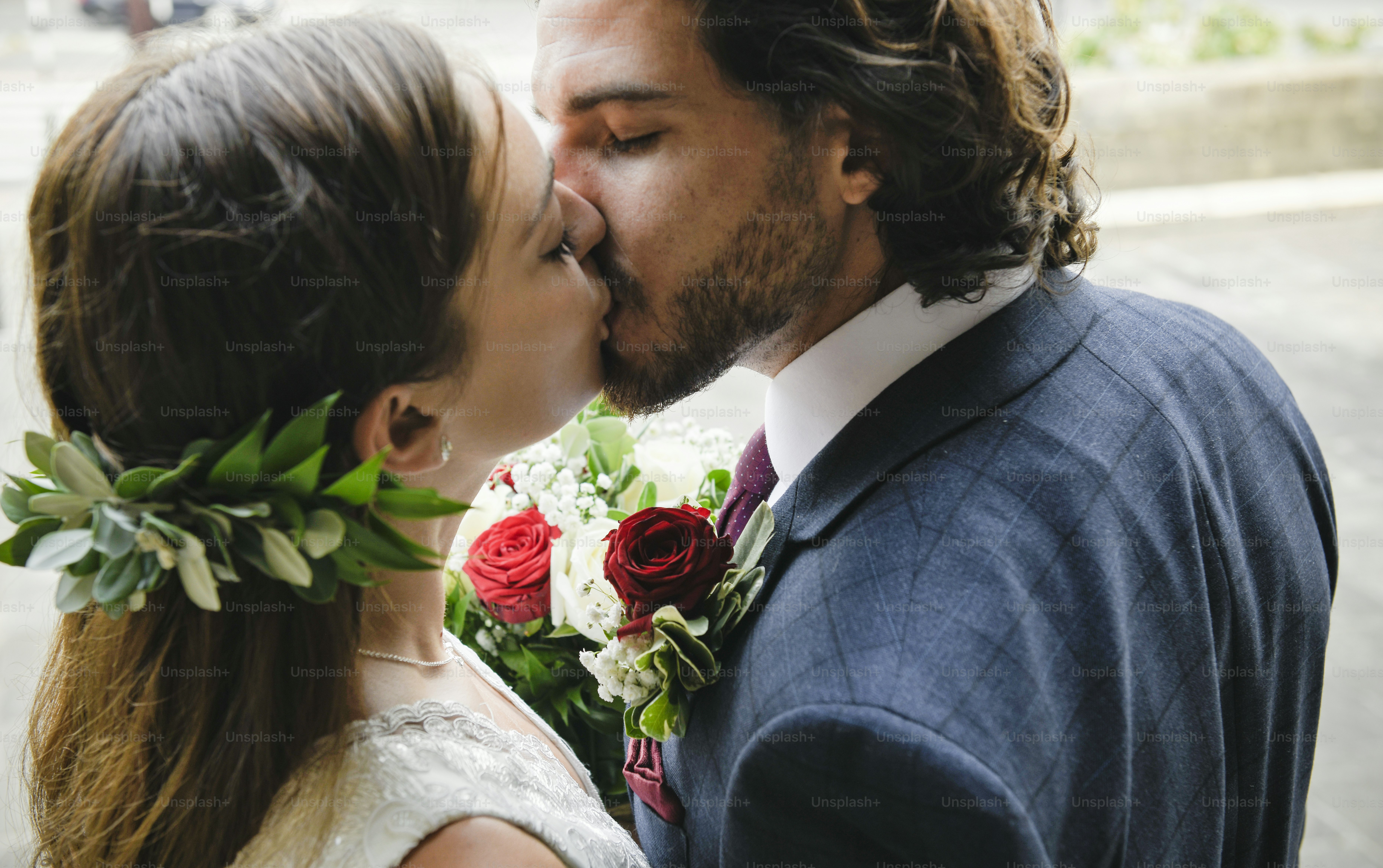 Bride and groom kissing outside the church