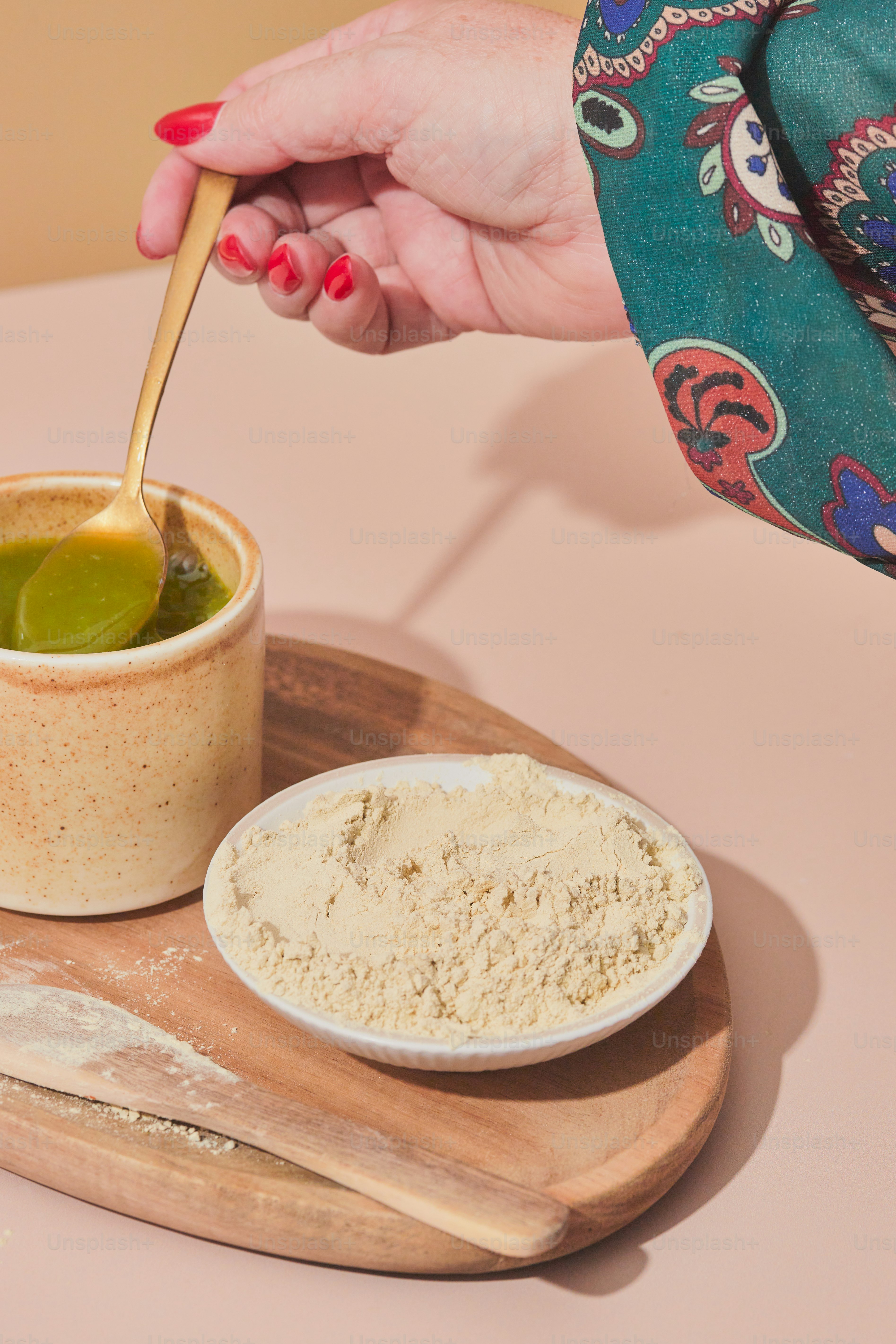 A person is dipping something into a bowl