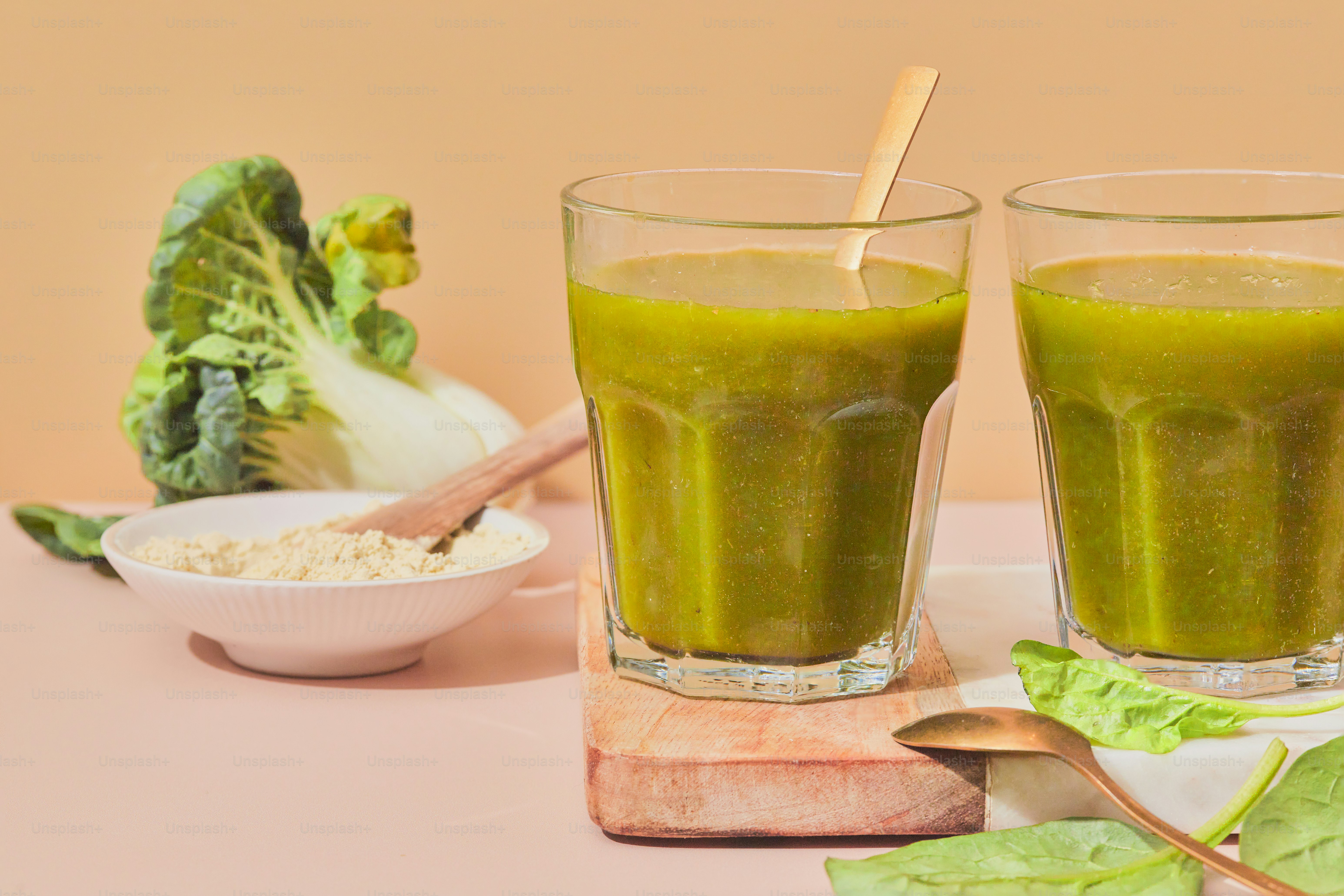 Two glasses of green smoothie on a table