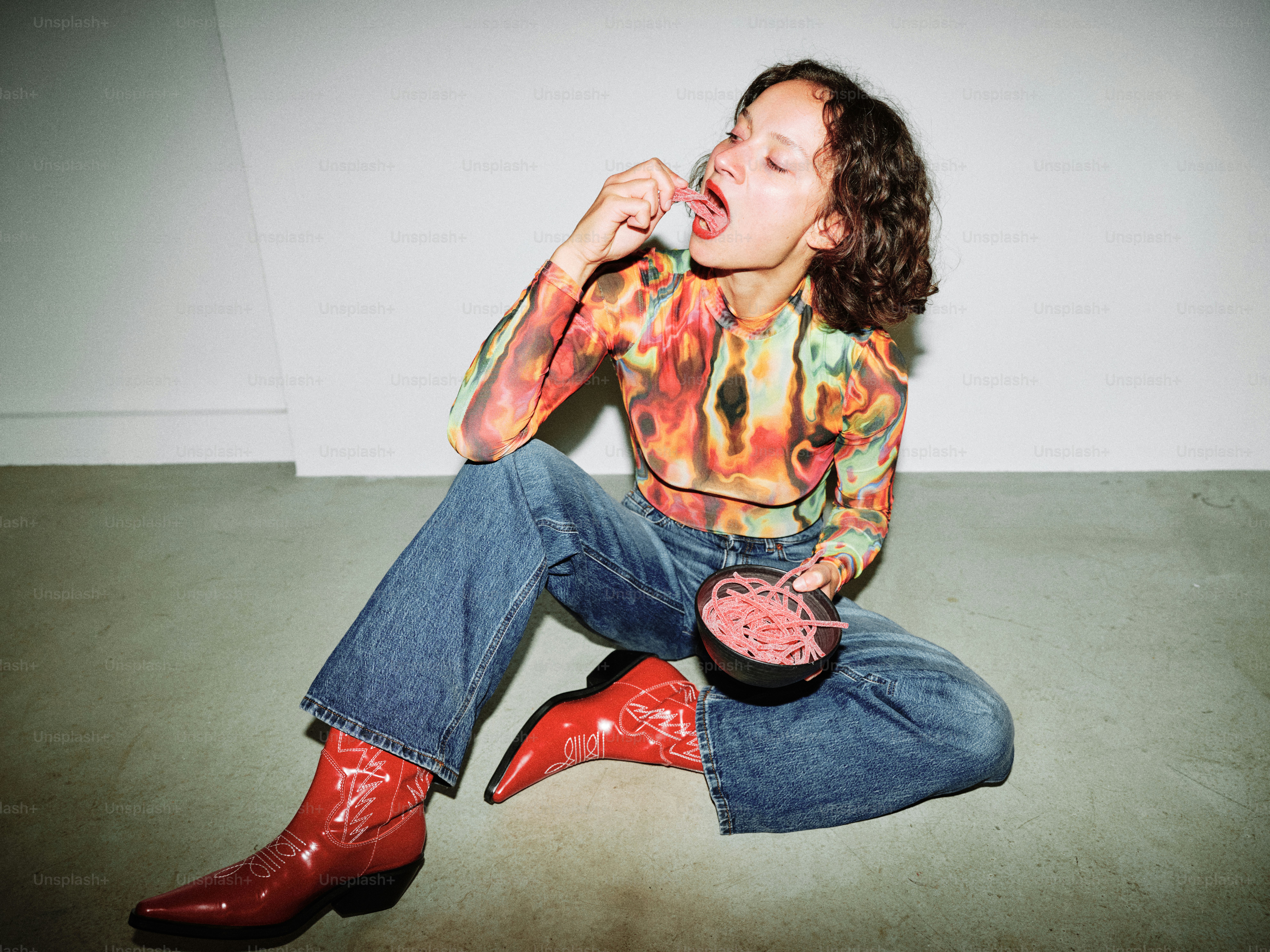 Une femme assise sur le sol, la bouche ouverte