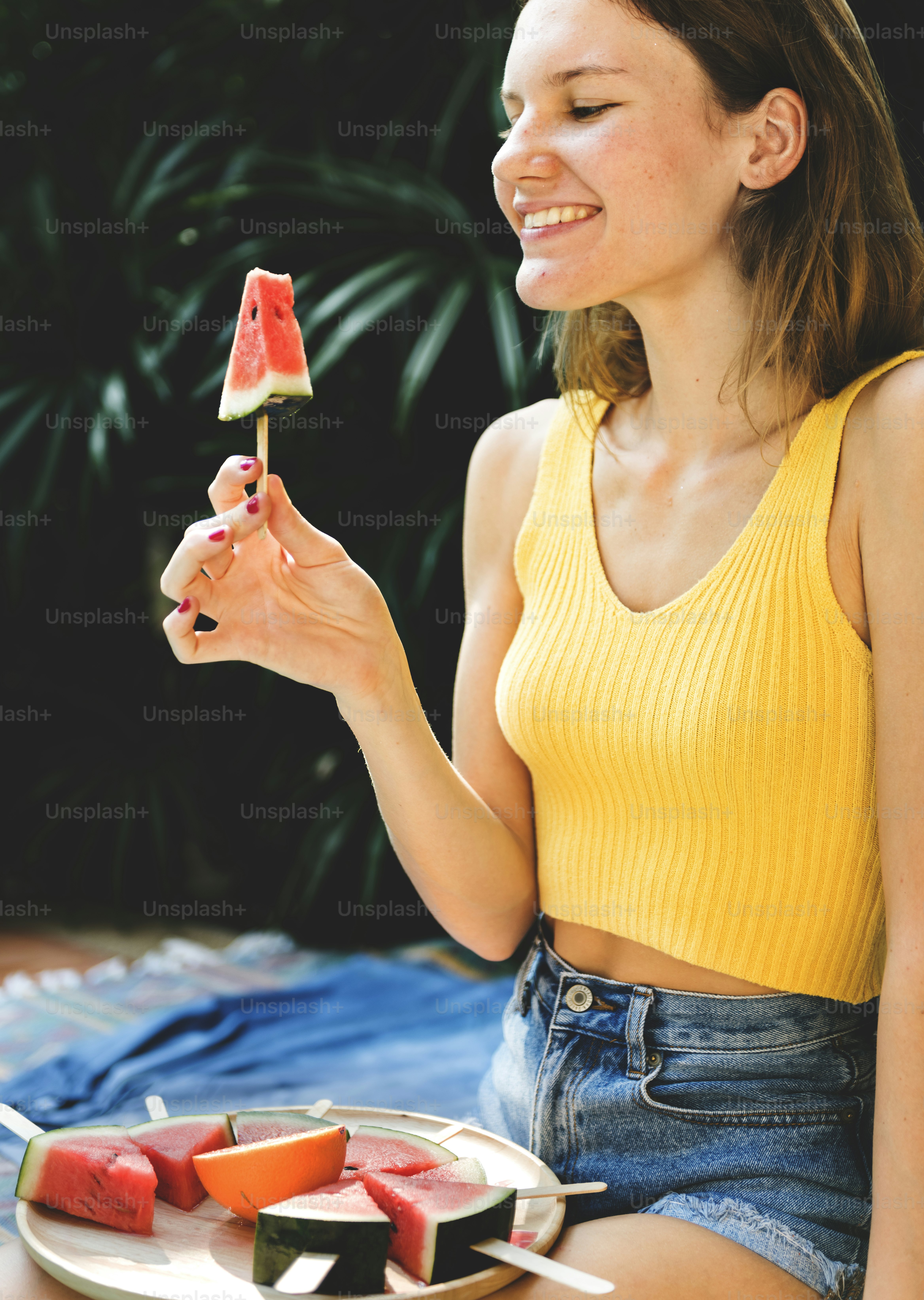 Caucasian woman eating watermelon in summertime