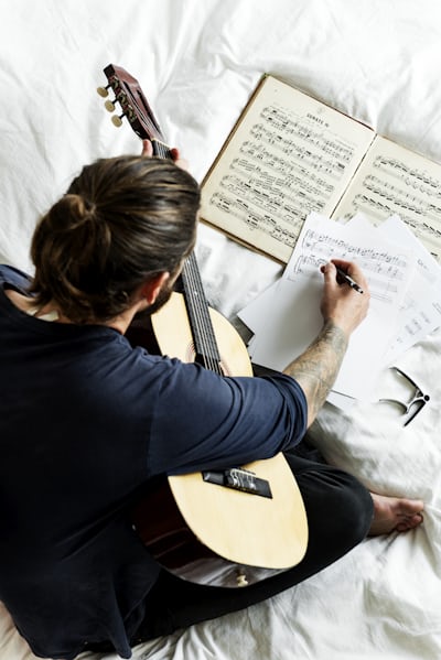Photo of guitarist transcribing sheet music