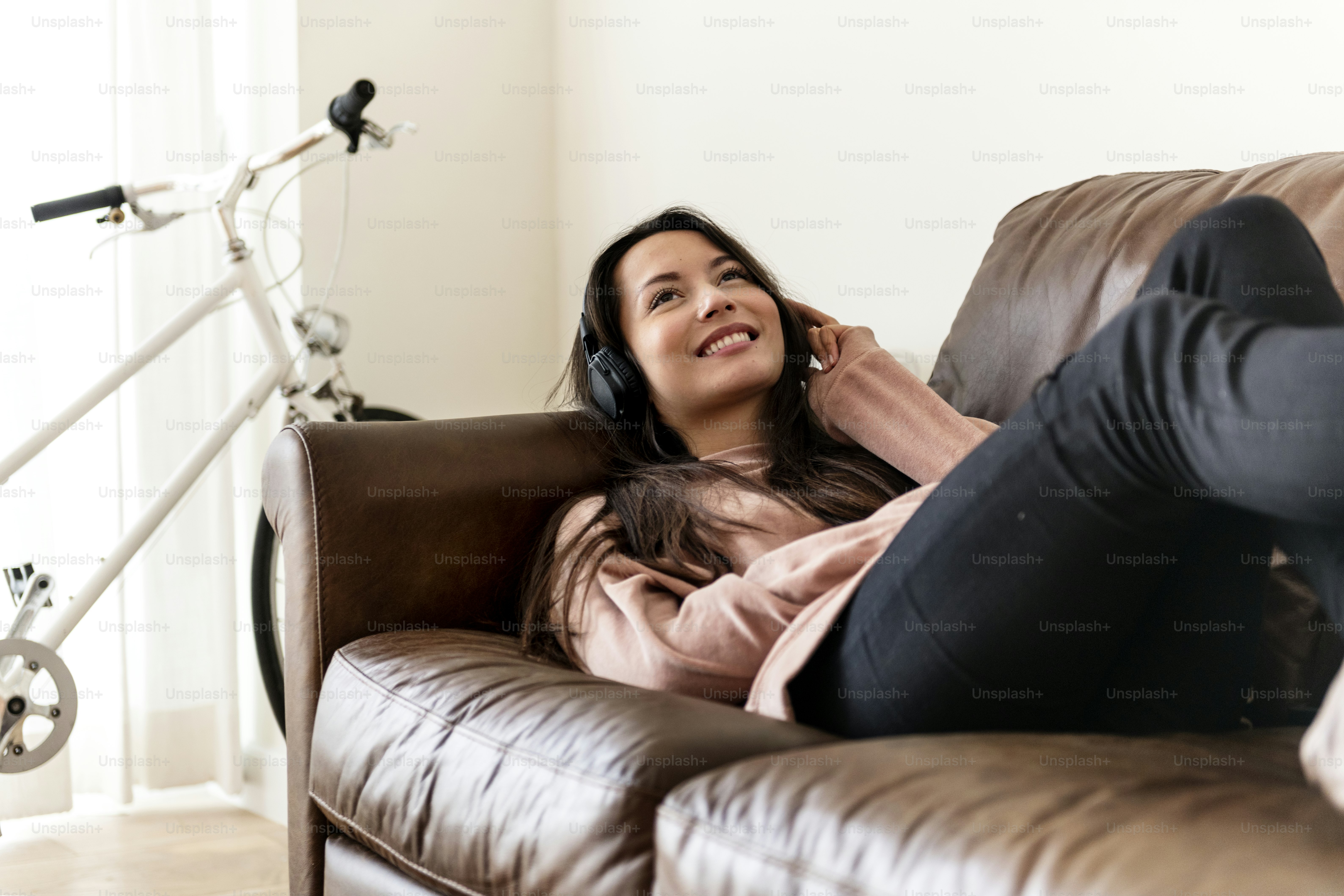 Girl listening to music at home on the sofa