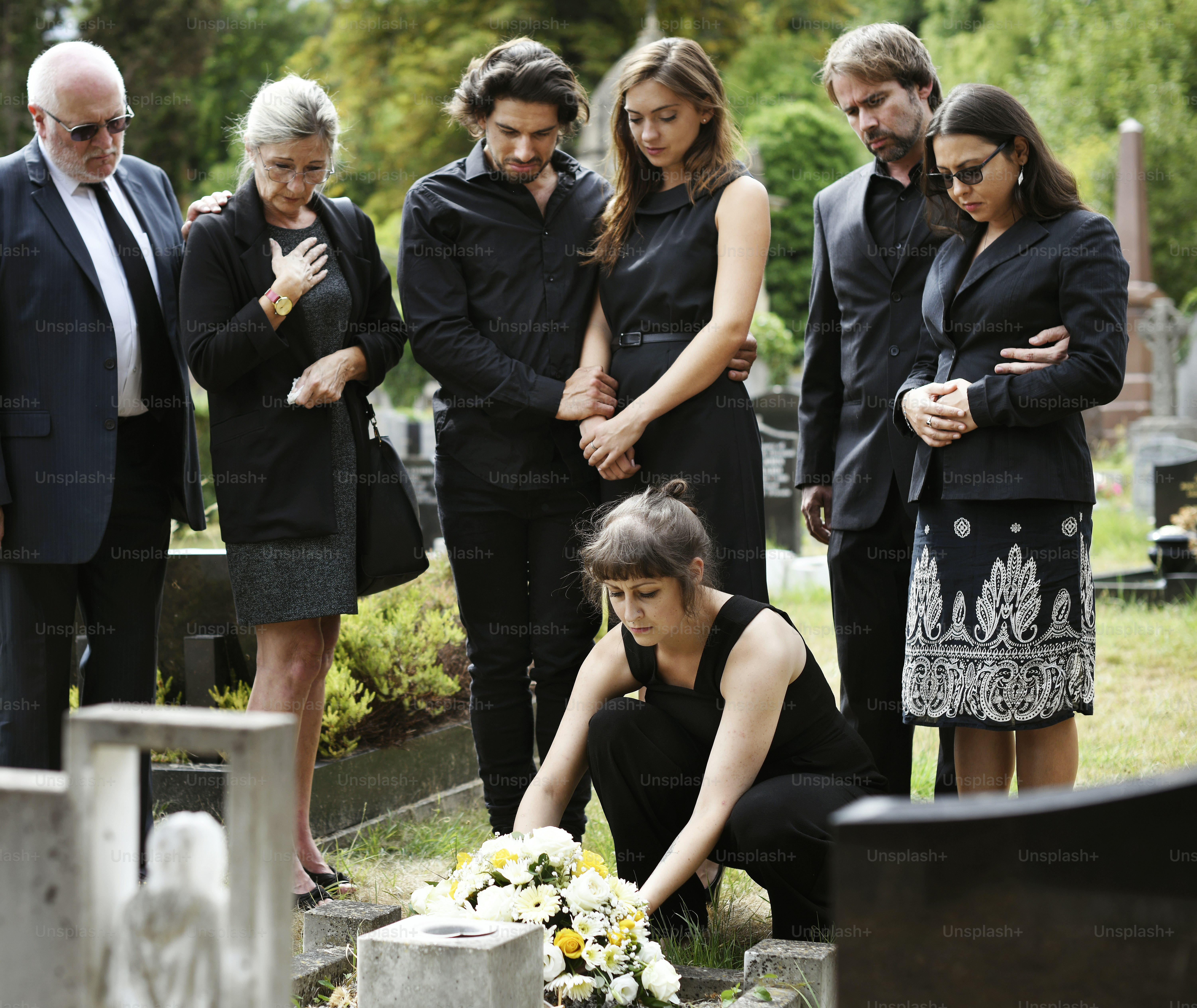 Family laying flowers on the grave