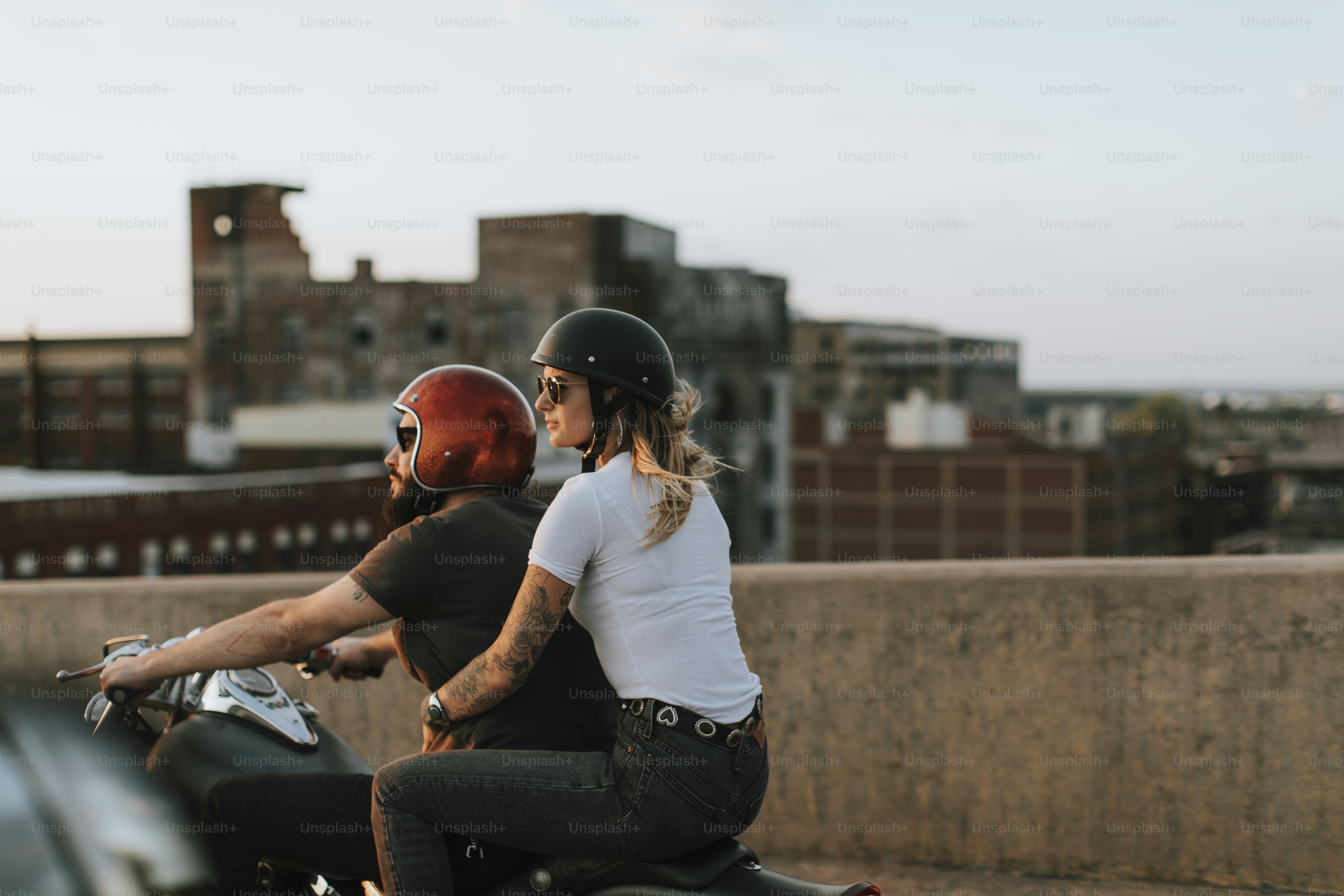 Biker couple riding down the road in the sunset