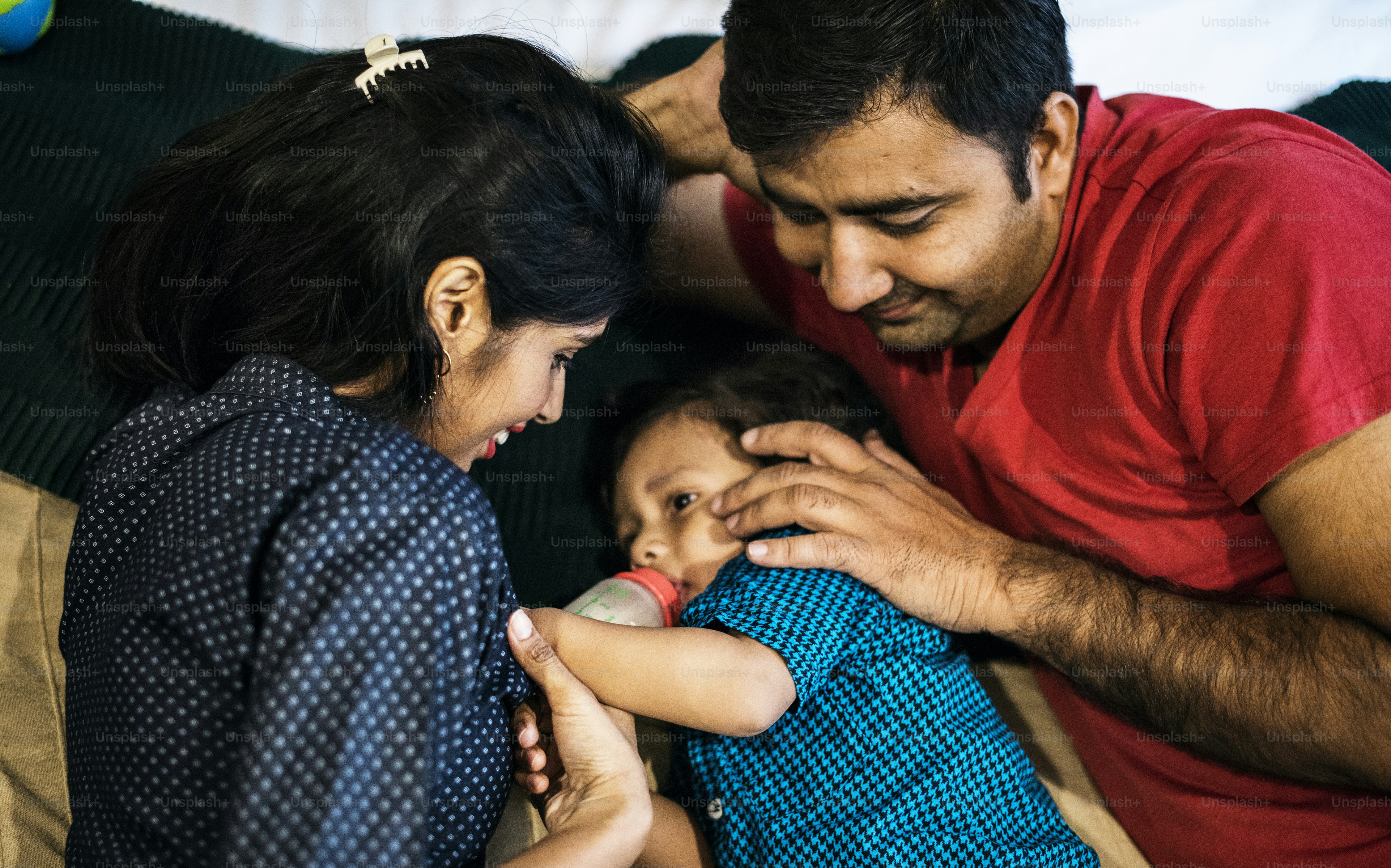 Parents caring for their baby during a relaxed feeding moment at home