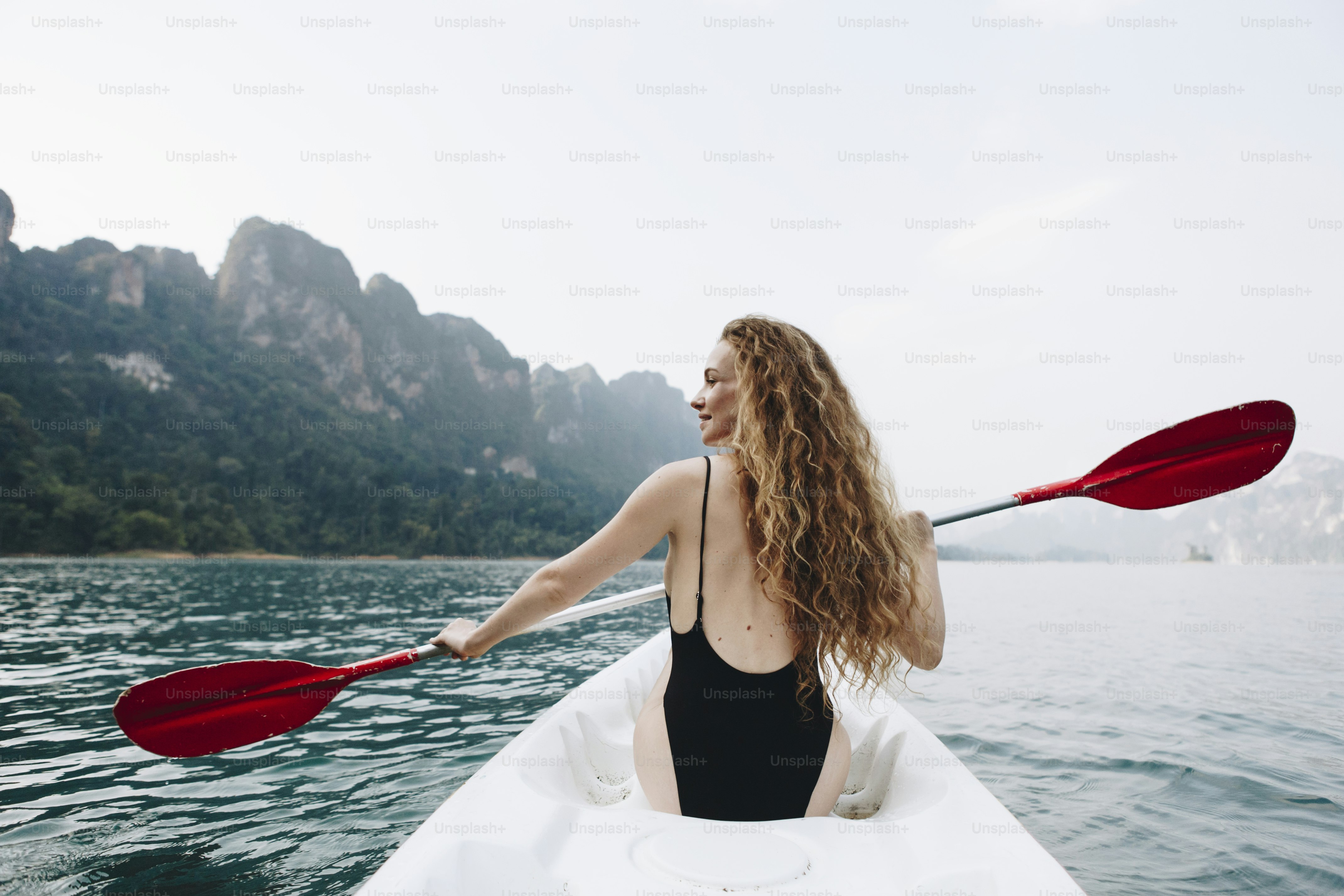 Woman paddling a canoe through a national park