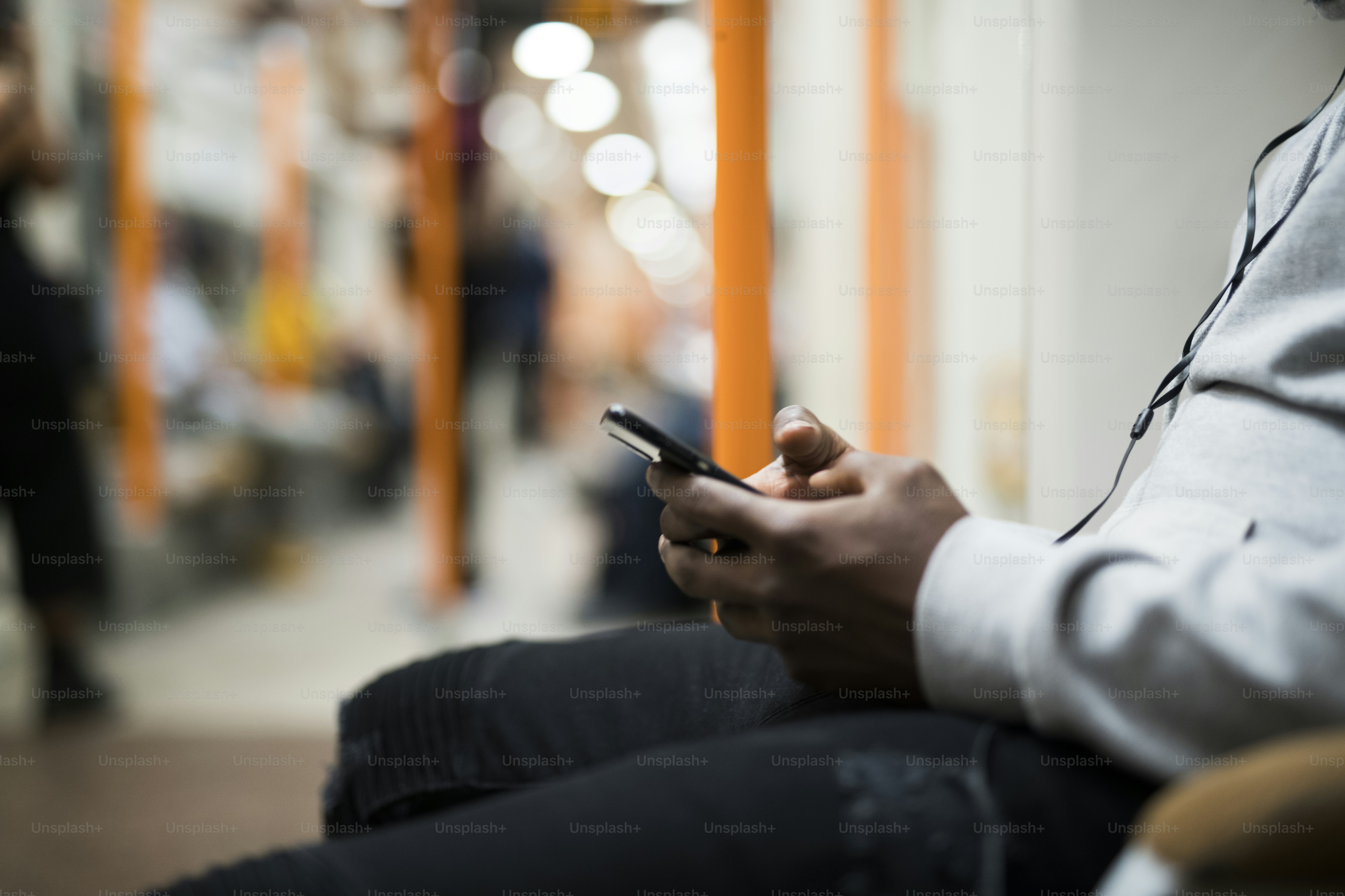 Close up of a man using his phone on the train