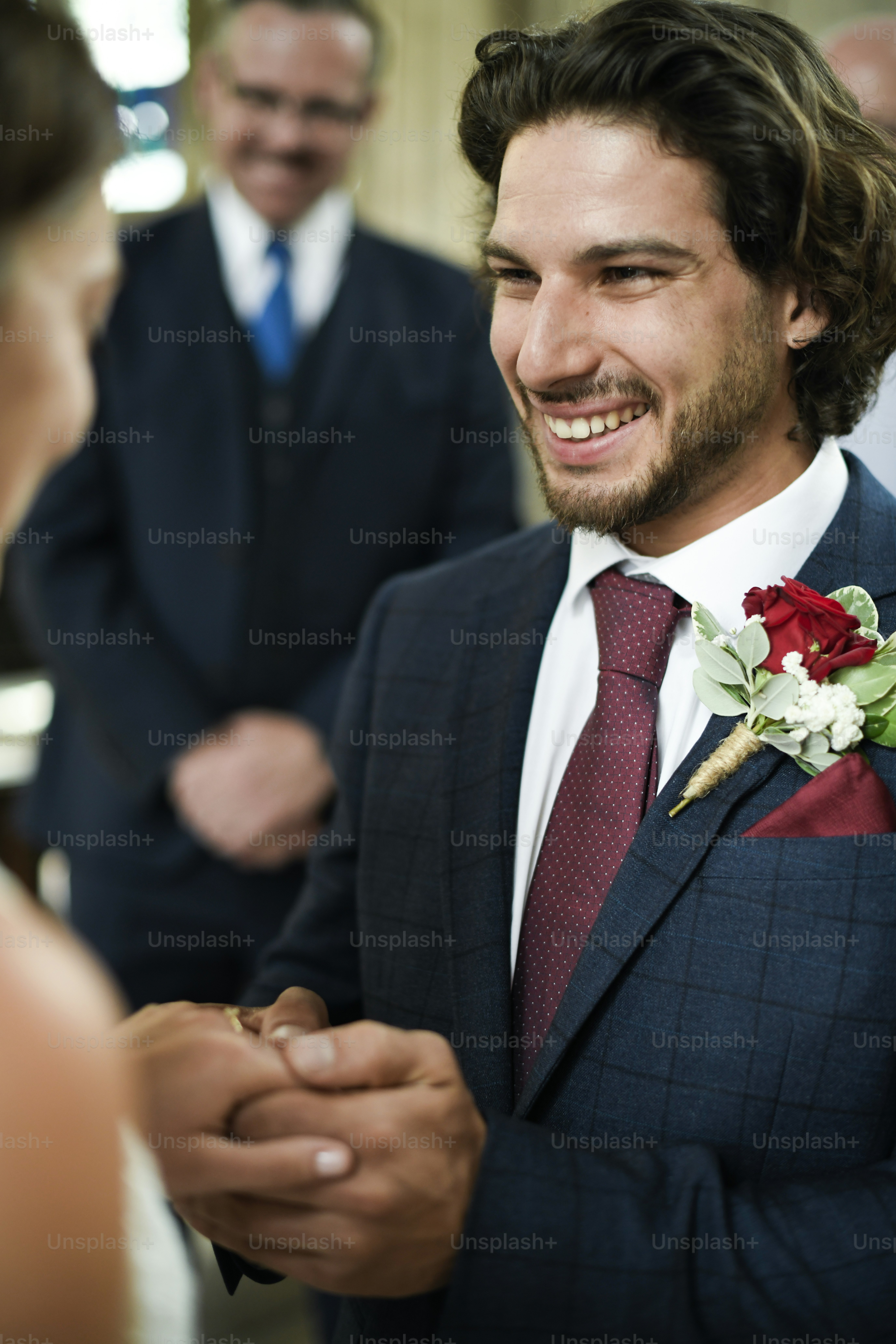 Groom putting on the wedding ring on his bride