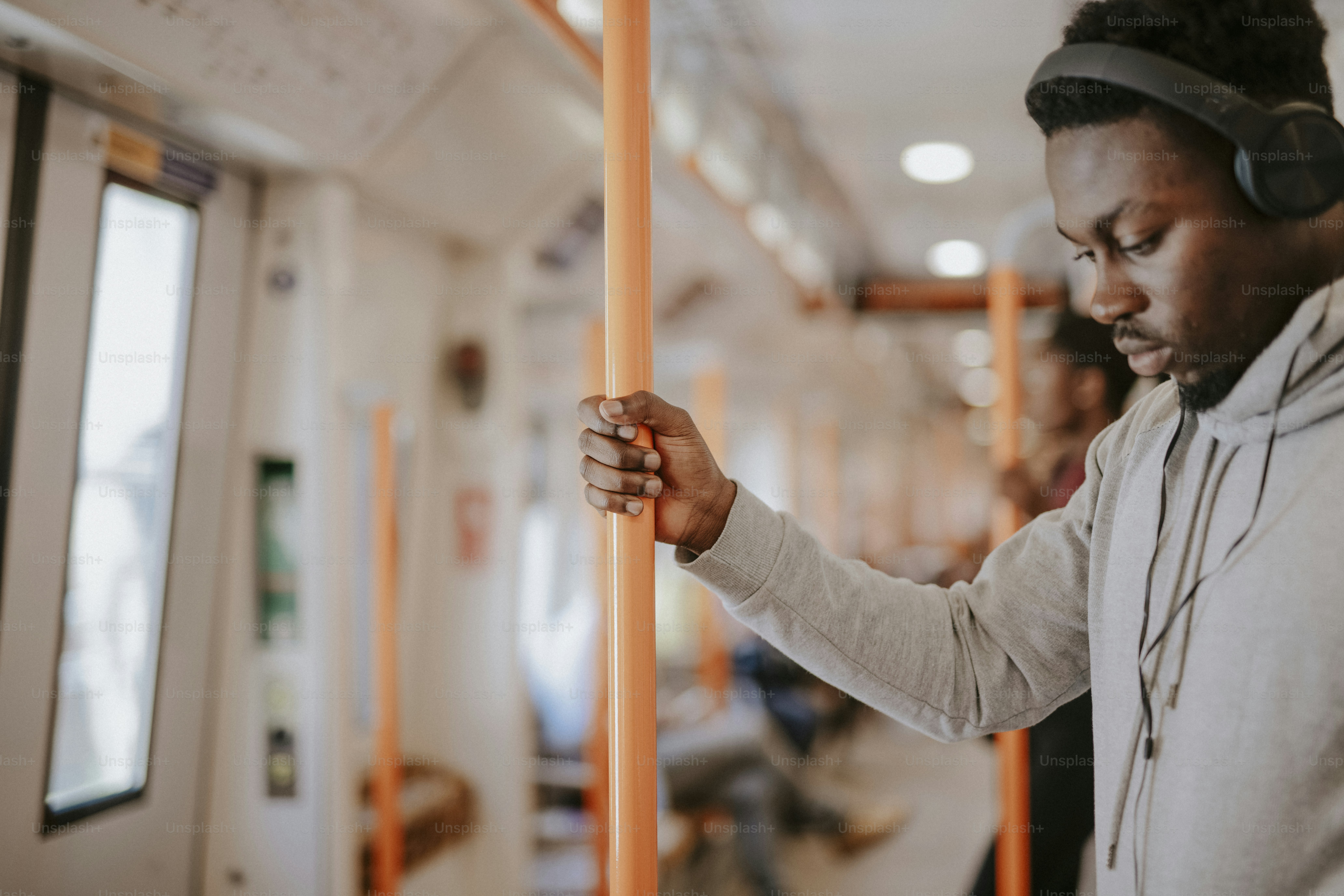 Standing passenger listening to music on the train
