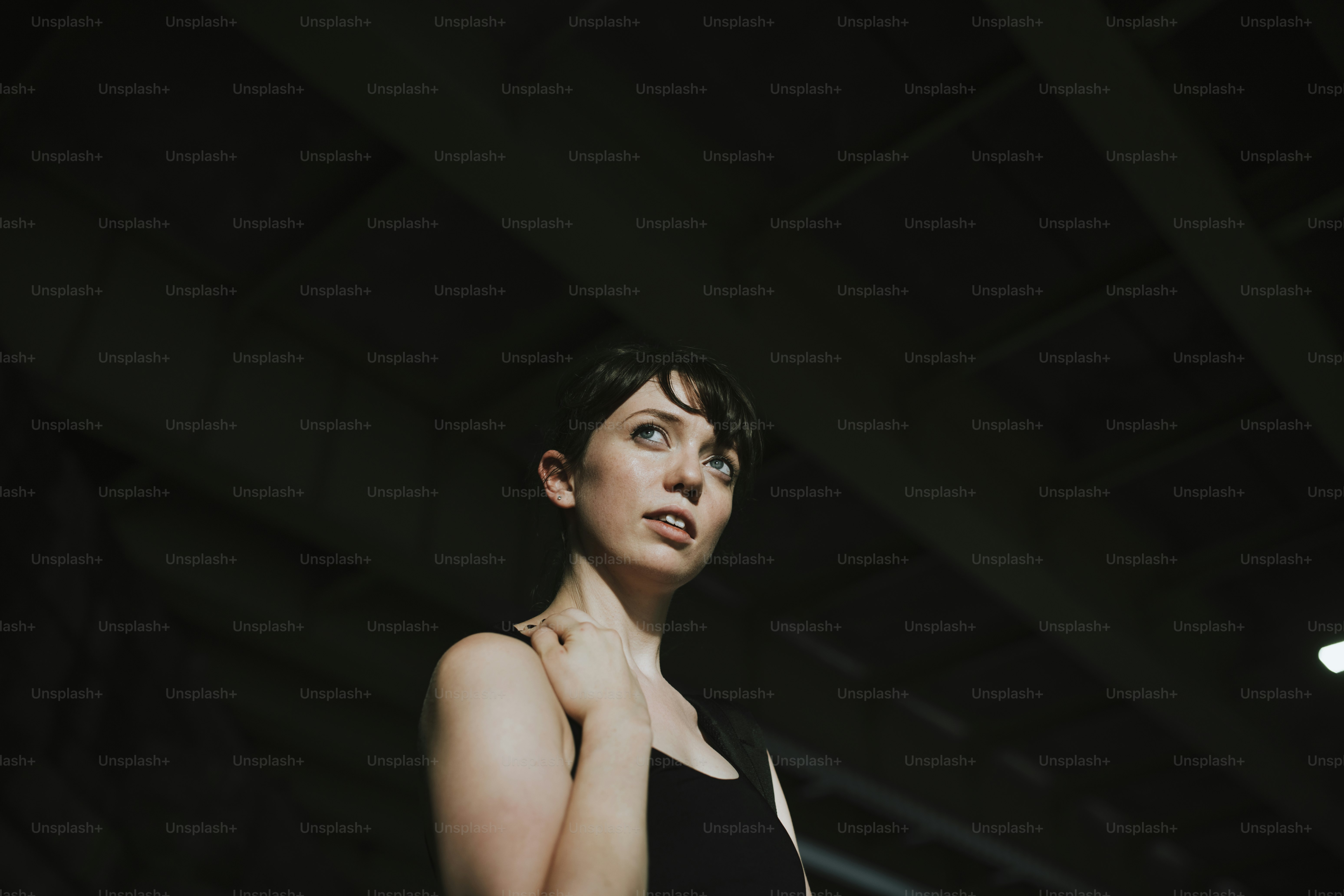 Beautiful woman standing in the dark alley