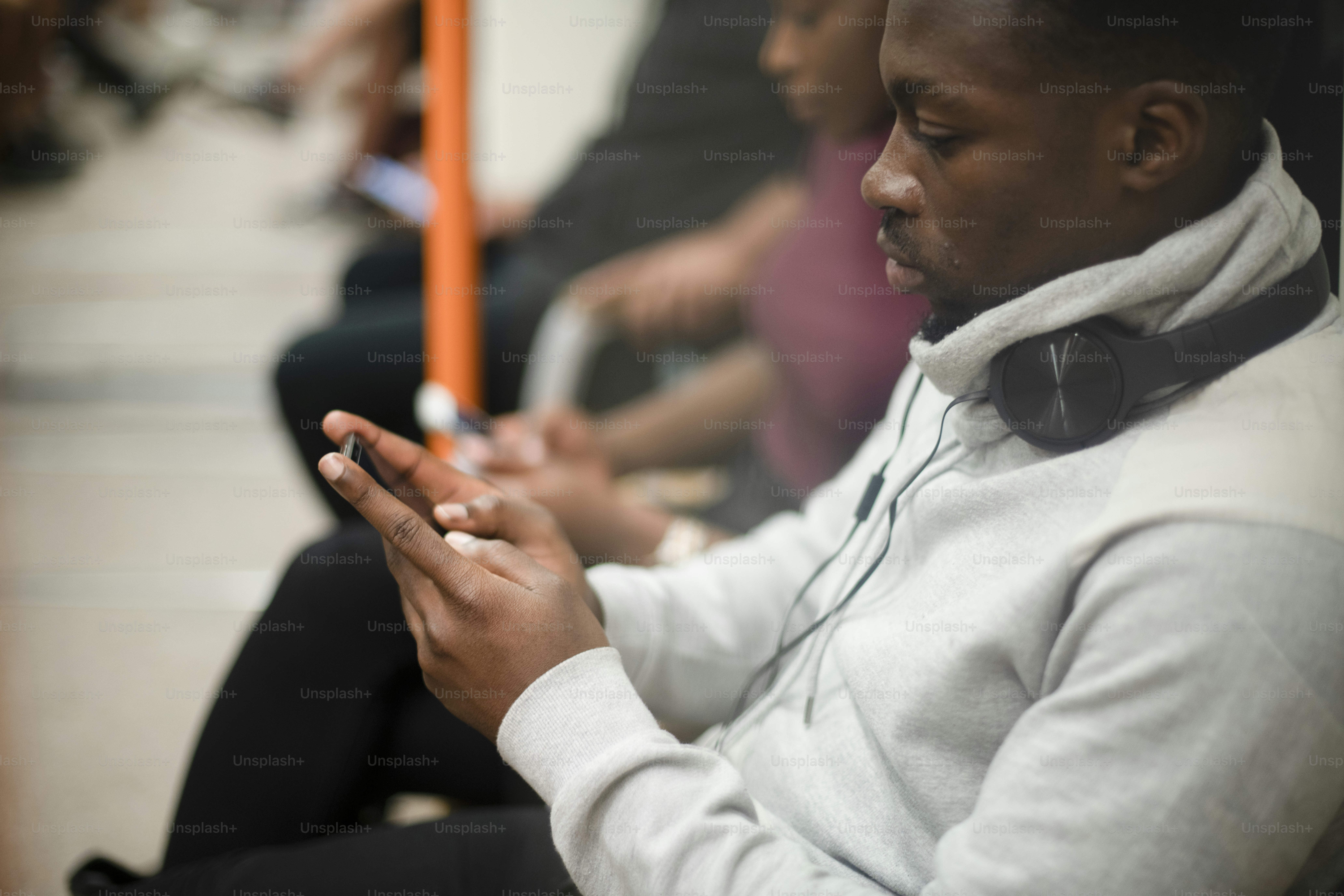 Bored man texting while on the train