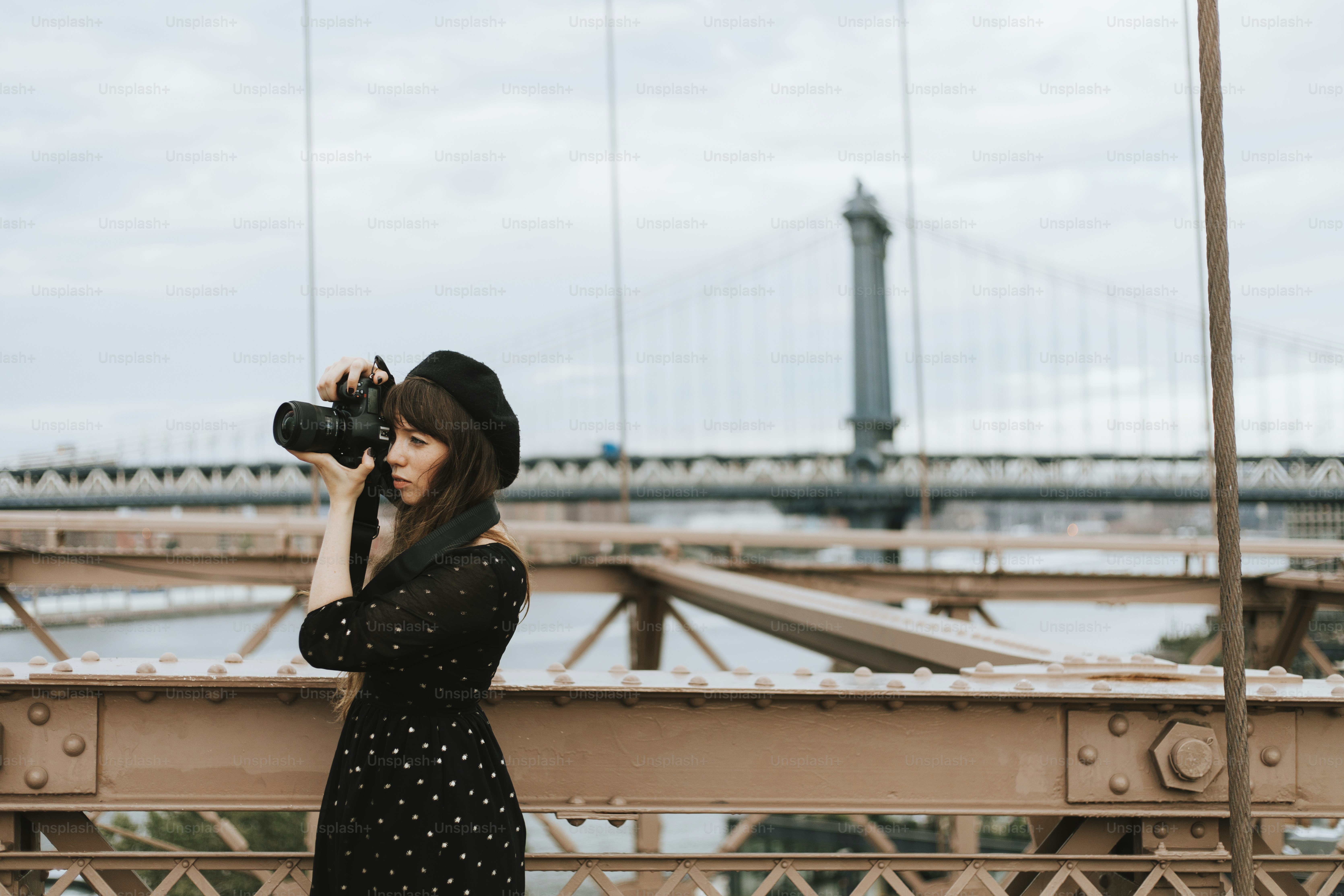 Photographer taking a photo at the Brooklyn Bridge, USA