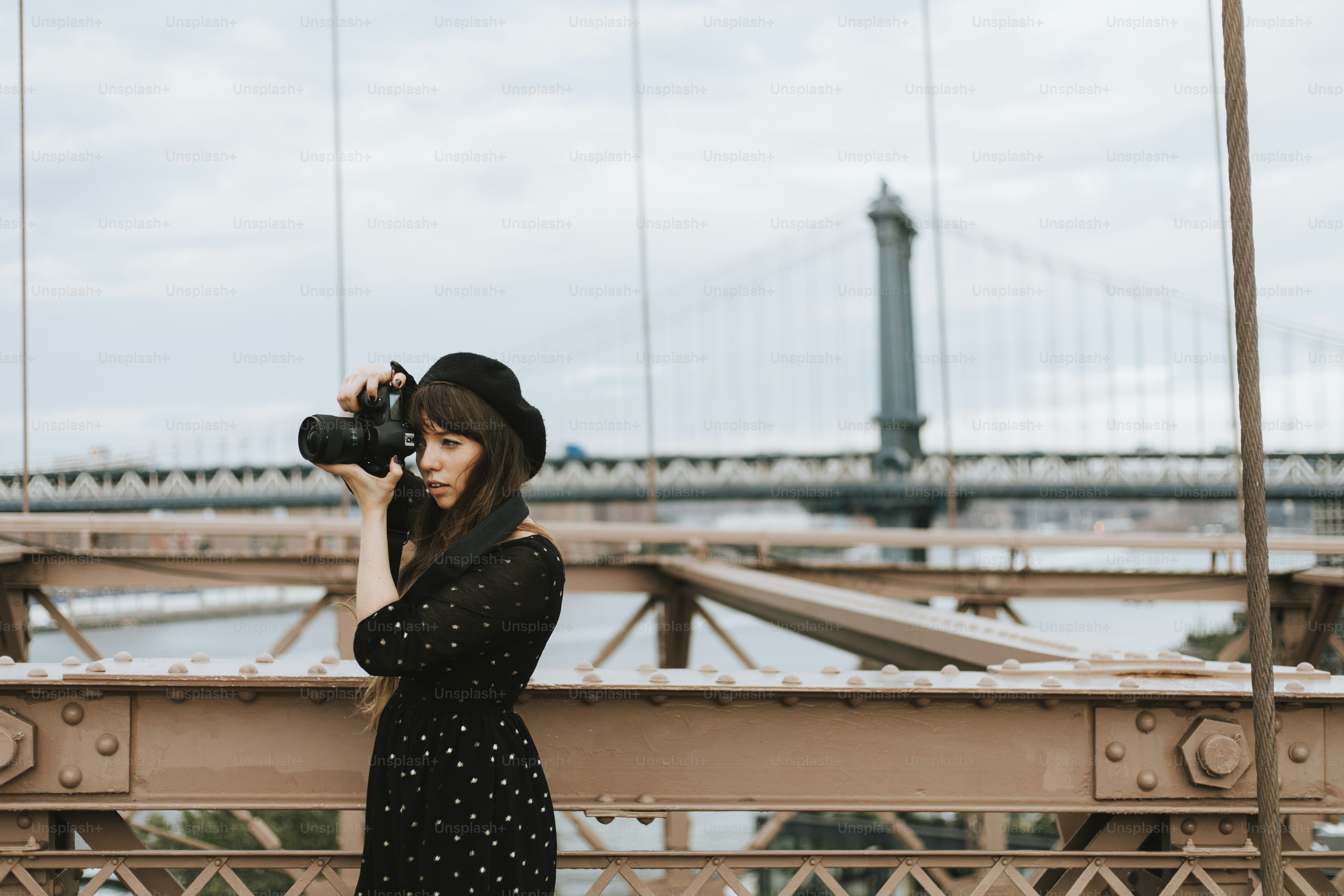 Photographer taking a photo at the Brooklyn Bridge, USA