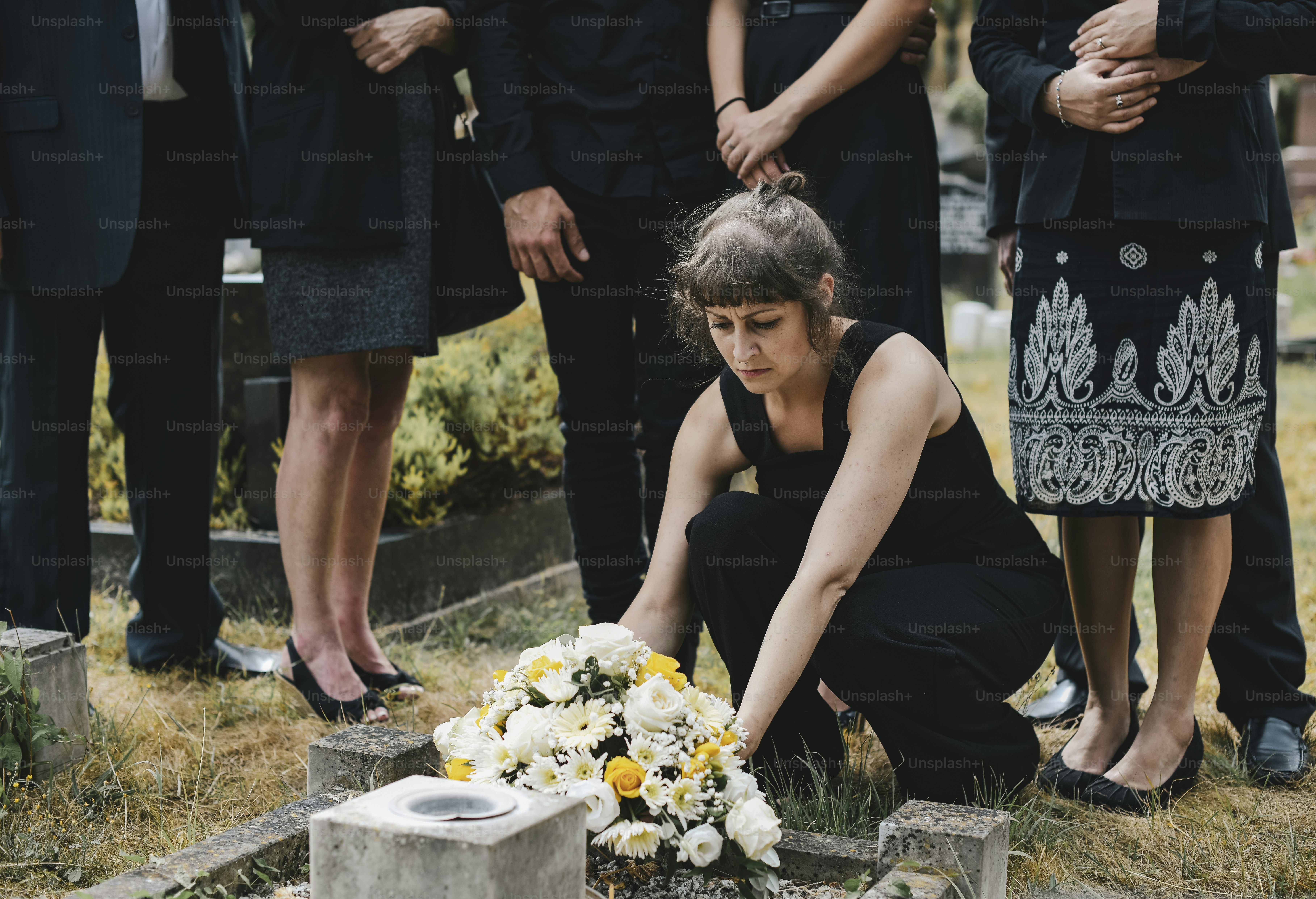 Family laying flowers on the grave
