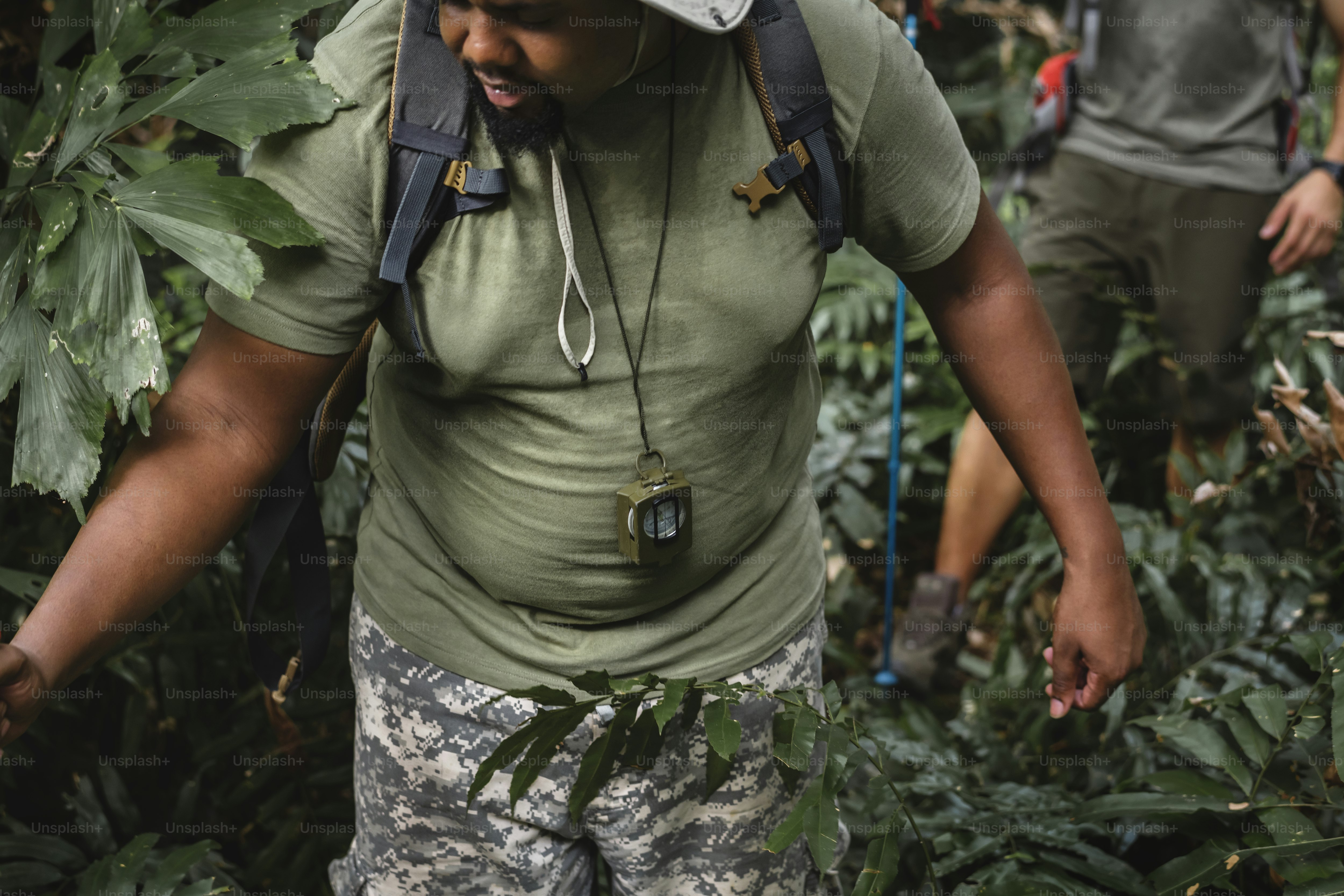 Man trekking in the forest with friends photo – Black people Image on ...