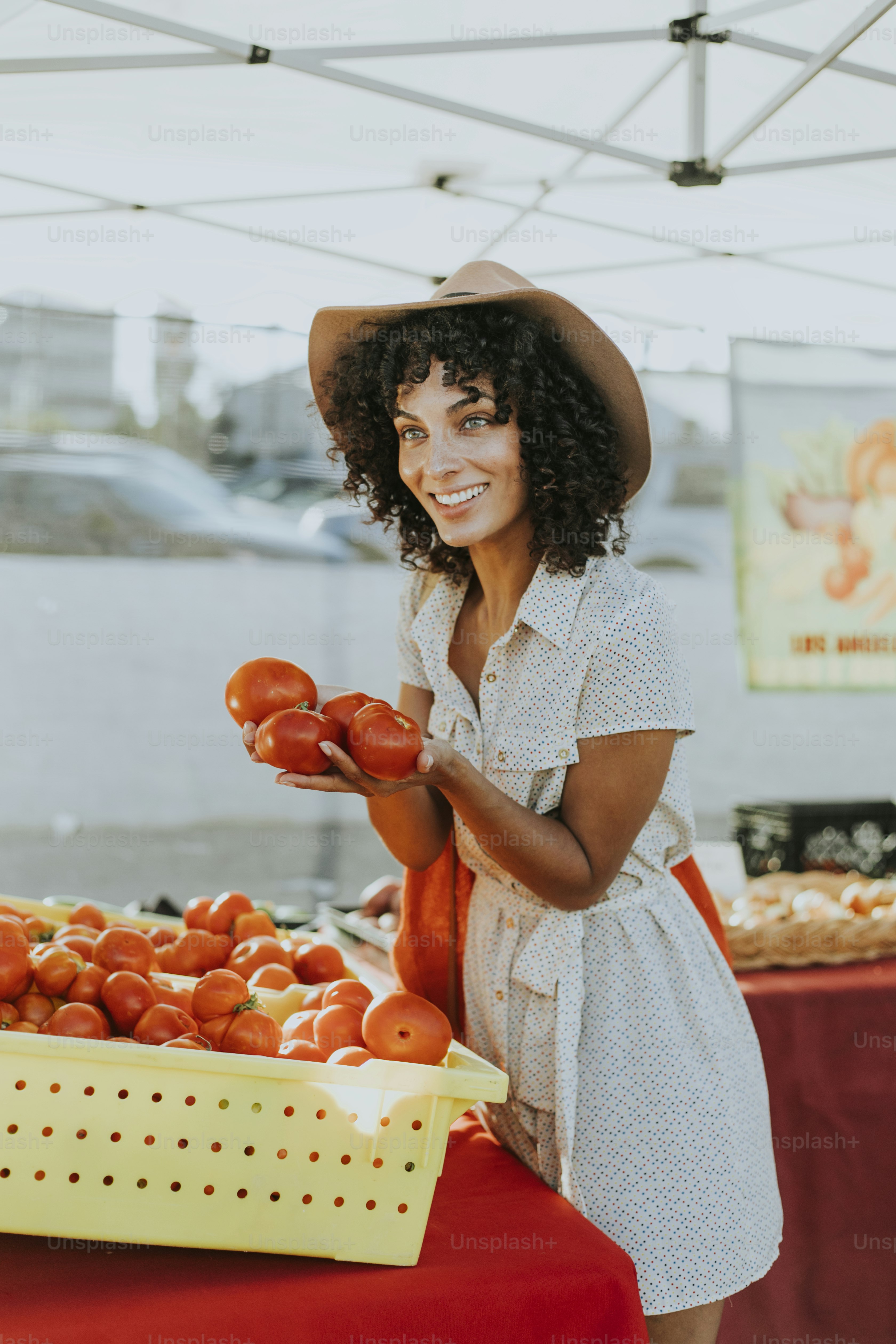 Woman buying tomatoes at a farmers market