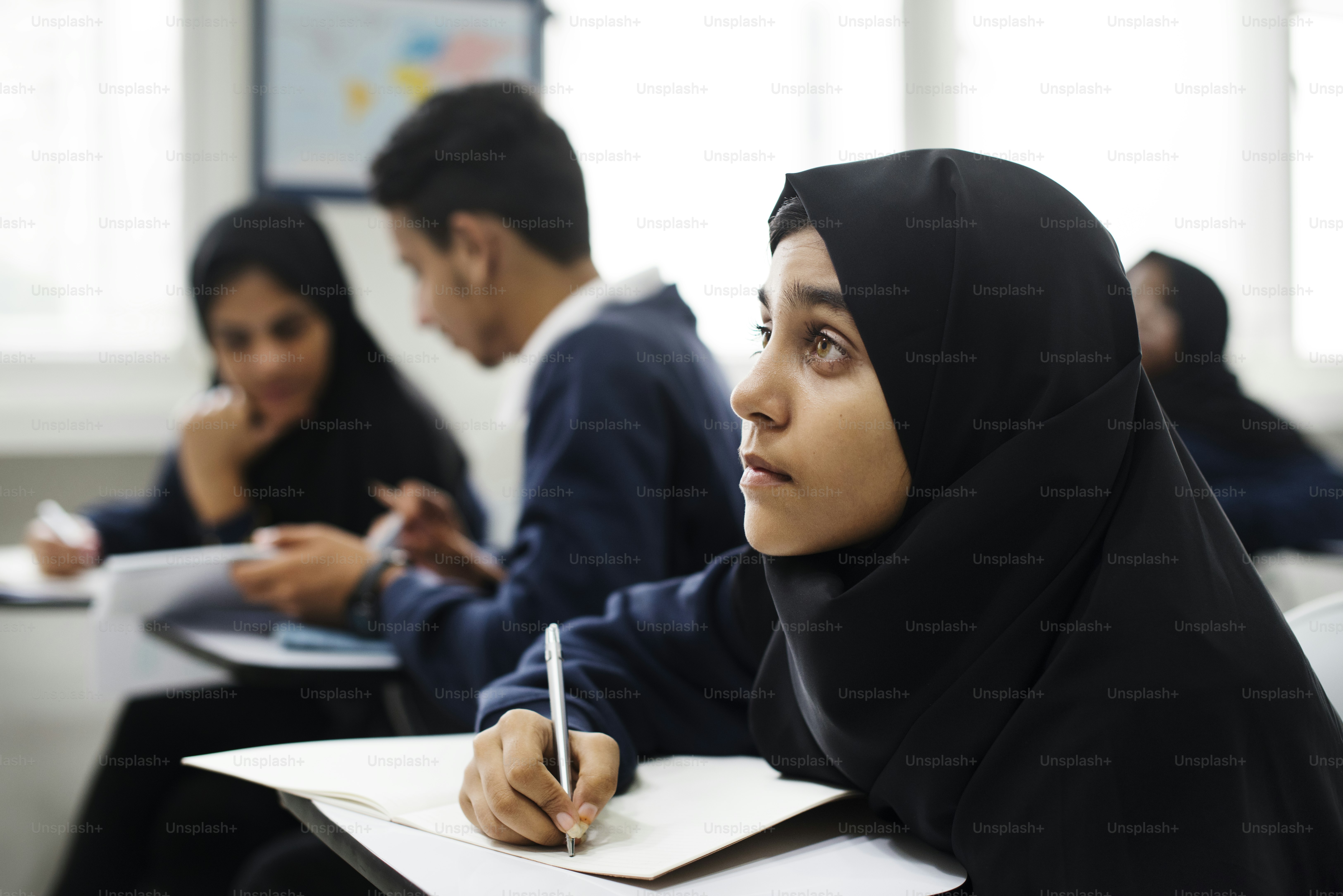 diverse muslim children studying in classroom